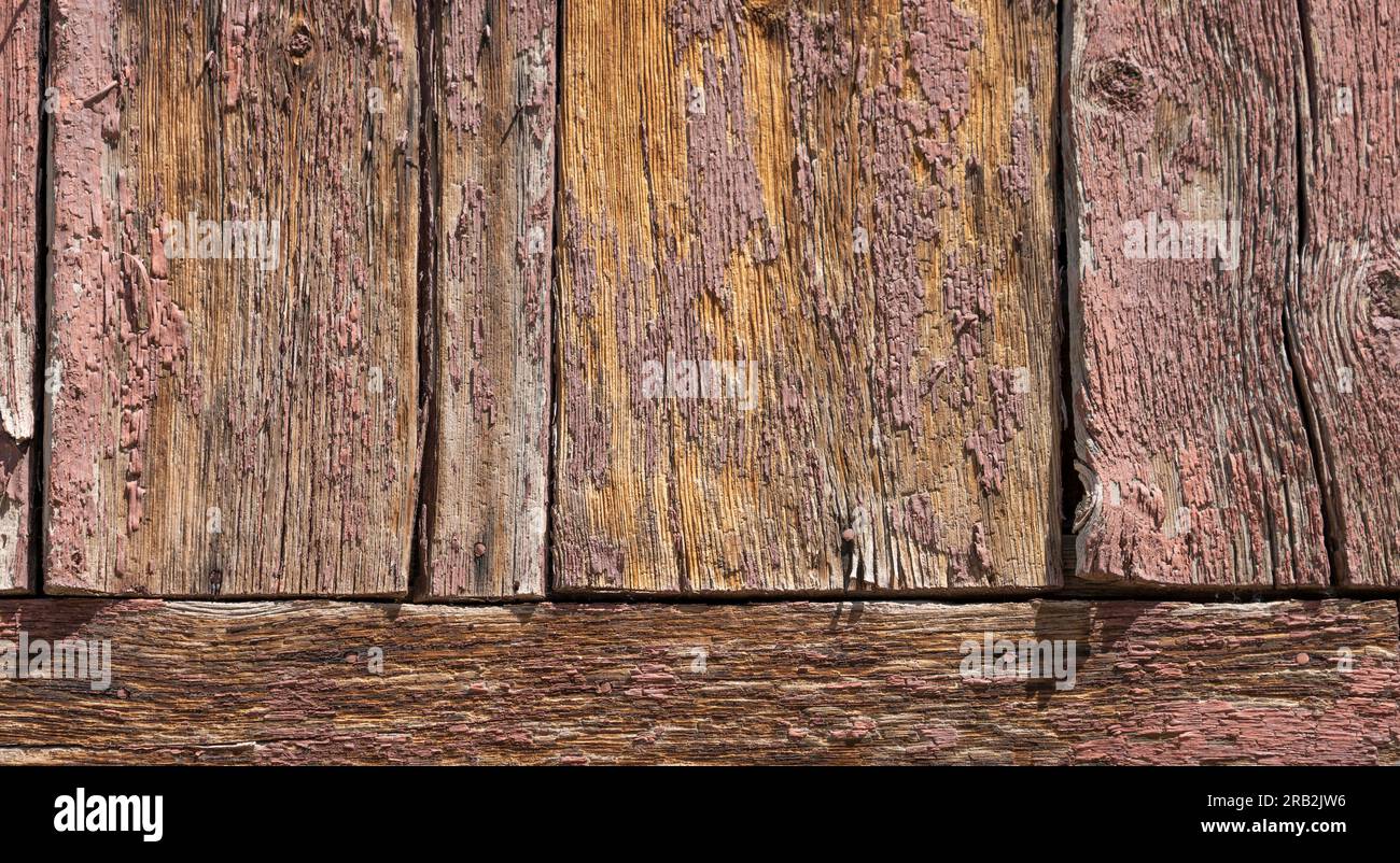 Siehe Bretter im alten Gebäude. Verwittert, lackiert, unlackiert, abblätternd kann man alles aus nächster Nähe an veralteten Holzhütten sehen. Zusammengesetzte Holzstücke. Stockfoto