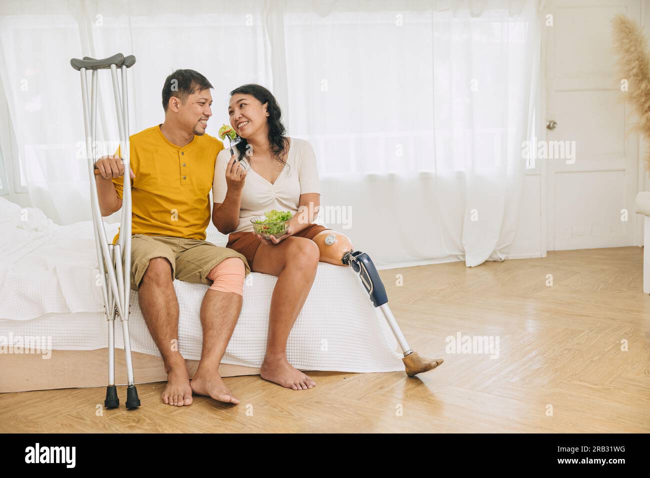 Paar Familie Beinverletzung Ehemann mit Ehefrau prothetisches bionisches Bein zusammenleben gesunde Lebensweise essen Stockfoto