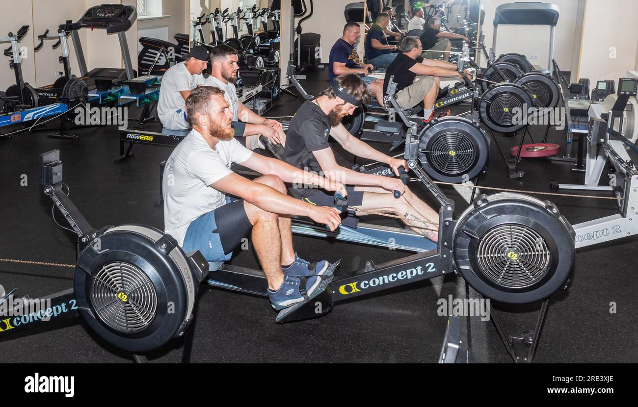 Eine Gruppe von Athleten wird beim Krafttraining an den Trainingsgeräten im Fitnessstudio beobachtet. Training und Vorbereitung behinderter Sportler auf die internationalen Invictus Games Düsseldorf 2023., 9-16. September 2023. Die Invictus Games sind internationale Sportwettkämpfe im Paralympischen Stil. Die Invictus Games sollen Soldaten und Veteranen neue Möglichkeiten bieten, die das ultimative Opfer gebracht haben und bei der Ausübung ihrer Aufgaben auf dem Schlachtfeld verwundet, verletzt oder krank wurden. Die Invictus Games in der Ukraine unterstützen ukrainische Soldaten und Veteranen auf ihrem Weg zur physischen Wiedereingliederung Stockfoto