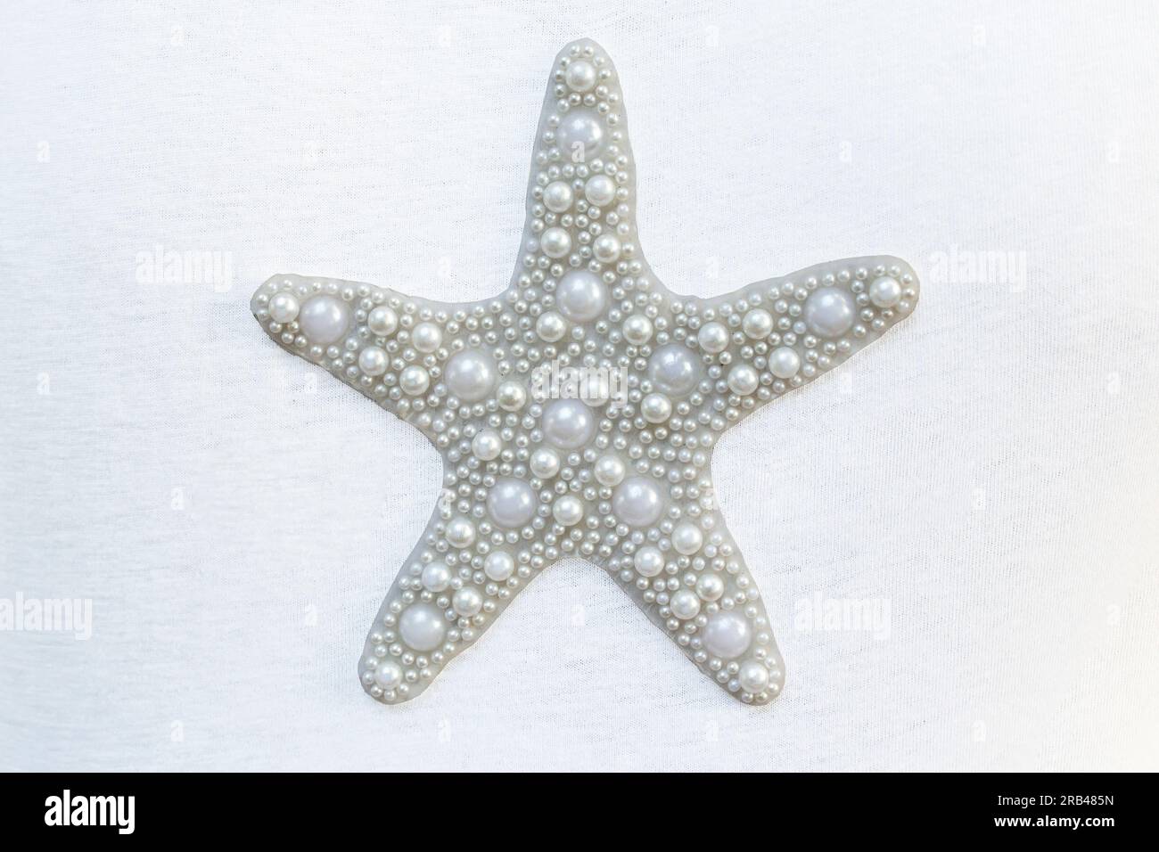 Fünf spitzer Stern aus weißen Perlen, isoliert auf weißem Hintergrund, weicher Fokus Nahaufnahme Stockfoto