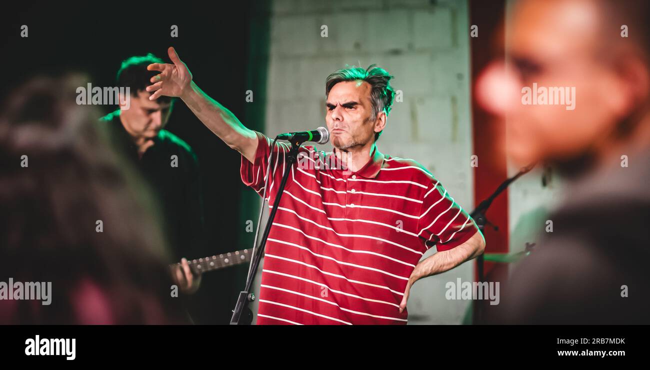 Punk-Rock-Musikband-Gruppe. Der Sänger, der Künstler ist, nimmt während einer Live-Aufführung auf einer Bühne ein Porträt auf Stockfoto