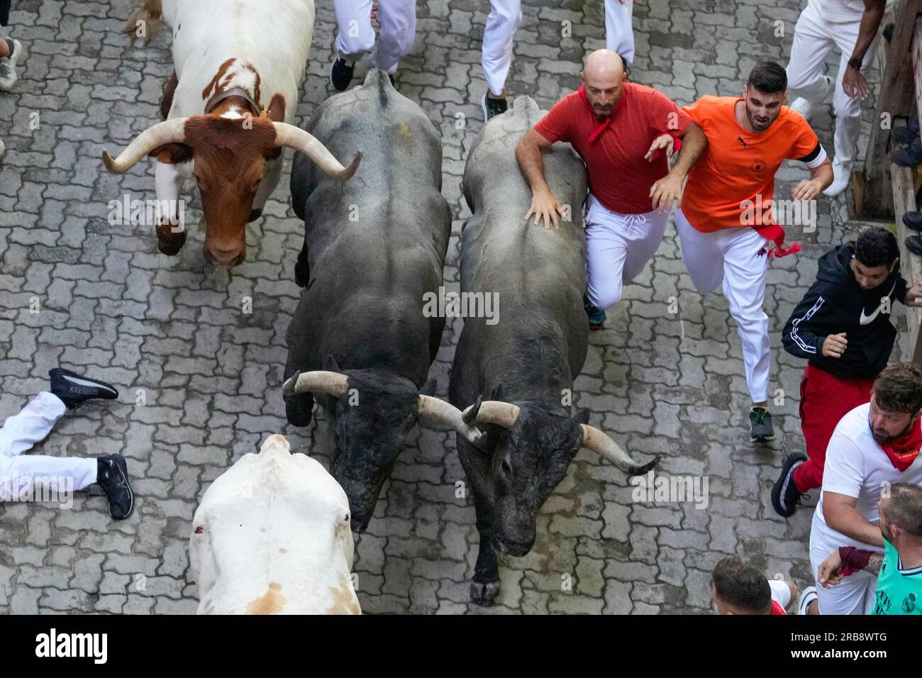 Pamplona, Spanien. 08. Juli 2023. Reveller springen am 8. Juli 2023 während der zweiten Runde der Stiere des San Fermin Festivals in Pamplona, Spanien. Tausende von Menschen nahmen an der zweiten von acht Bullenläufen durch die engen Gassen von Pamplonas Stadtzentrum Teil, an der Fiesta, deren internationaler Ruhm eng mit Ernest Hemingway verbunden ist, der es in seinem Buch „die Sonne geht auch auf“ beschreibt. Foto: Paul Hanna/UPI Credit: UPI/Alamy Live News Stockfoto