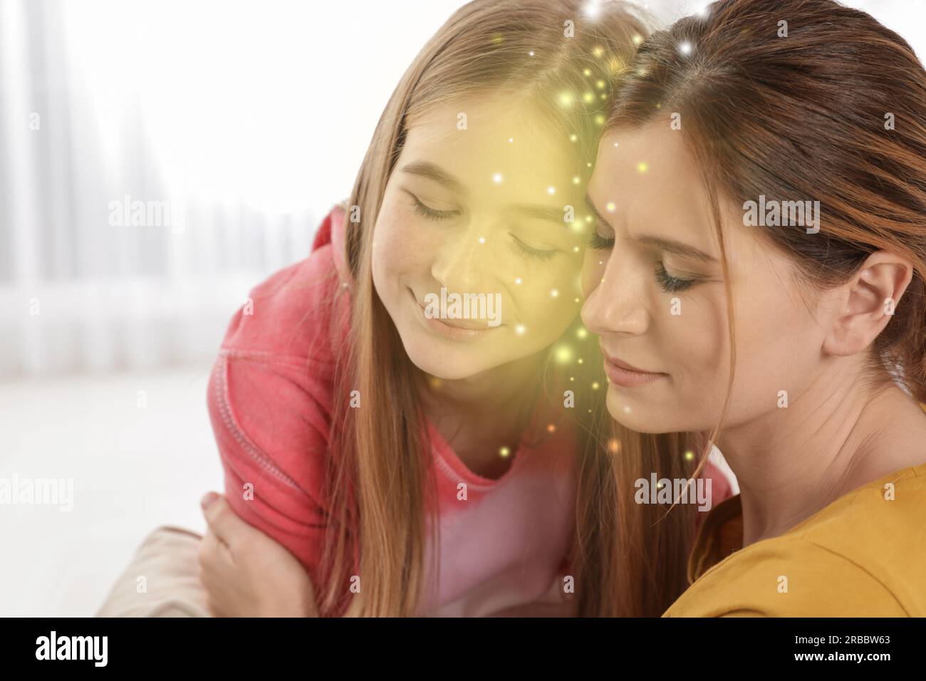 Einfühlungsvermögen. Mutter umarmt ihre friedliche Teenager-Tochter drinnen. Licht dazwischen als Symbol für emotionale Unterstützung und Verständnis Stockfoto