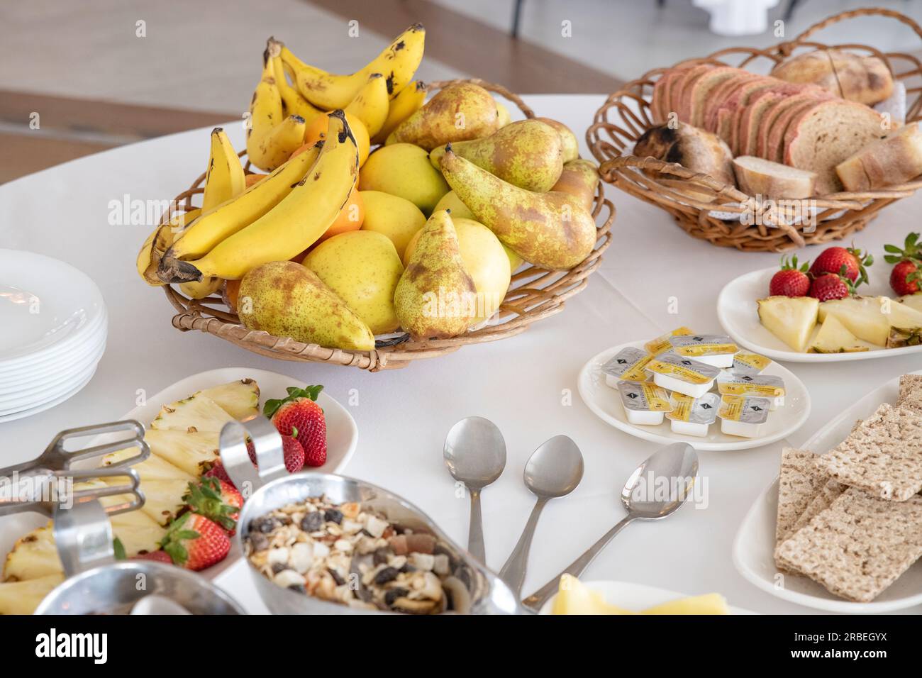 Die Frühstücksbar bietet eine Auswahl an köstlichen Speisen: Frisches Obst, Müsli und Nüsse, verschiedene Brotsorten und mehr für eine gesunde Ernährung Stockfoto