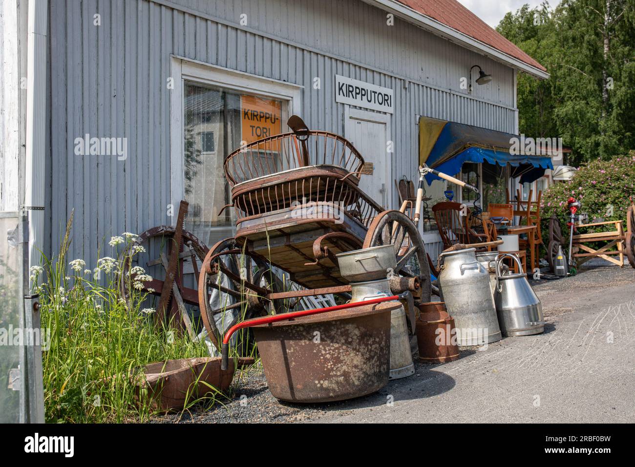 Alte und rostige landwirtschaftliche Artikel zum Verkauf vor dem Gebrauchtgeschäft in Kihniöntie 15 in Kihniö, Finnland Stockfoto
