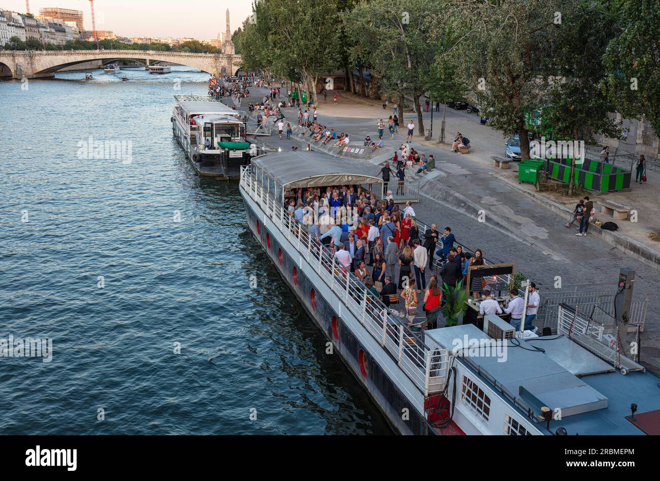 Romantisches Paris. Bei Sonnenuntergang versammeln sich die Menschen am linken seine-Ufer im Quartier Latin, um sich auf dem Boot zu treffen. Quai de la Tournelle, 5 Arr. Paris. Stockfoto