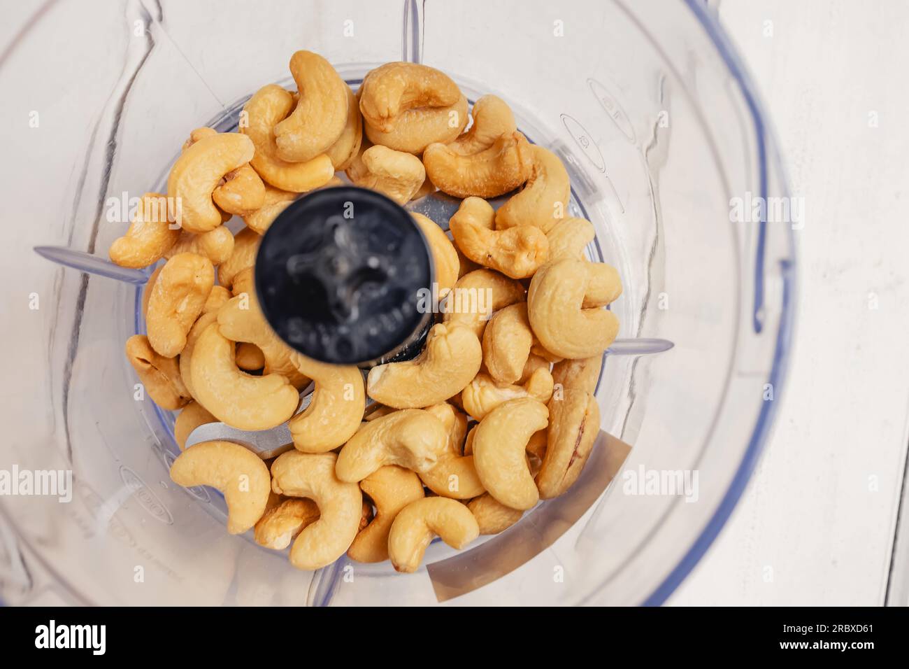 Cashewnüsse in einer Nahaufnahme aus dem Mixer, wodurch eine Alternative zu veganem Käse hergestellt wird Stockfoto