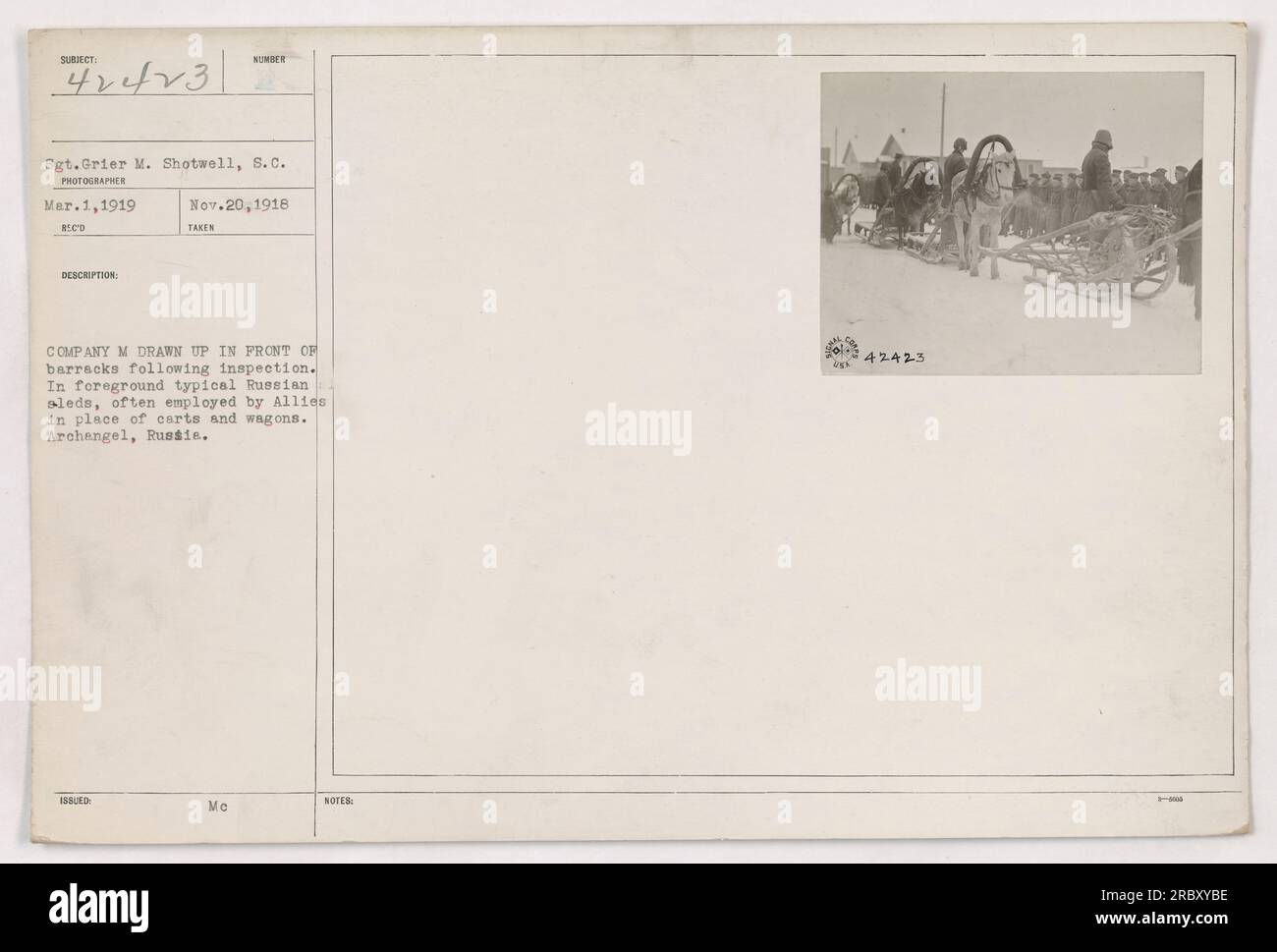 Sergeant Grier M. Shotwell von der S.C. Militäreinheit steht mit einer Gruppe Soldaten vor einer Kaserne, nach einer Inspektion am 1. März 1919 in Erchangel, Russland. Die Soldaten benutzten russische Schlitten, ein von den Alliierten verwendetes Transportmittel anstelle von Wagen und Wagen. Stockfoto