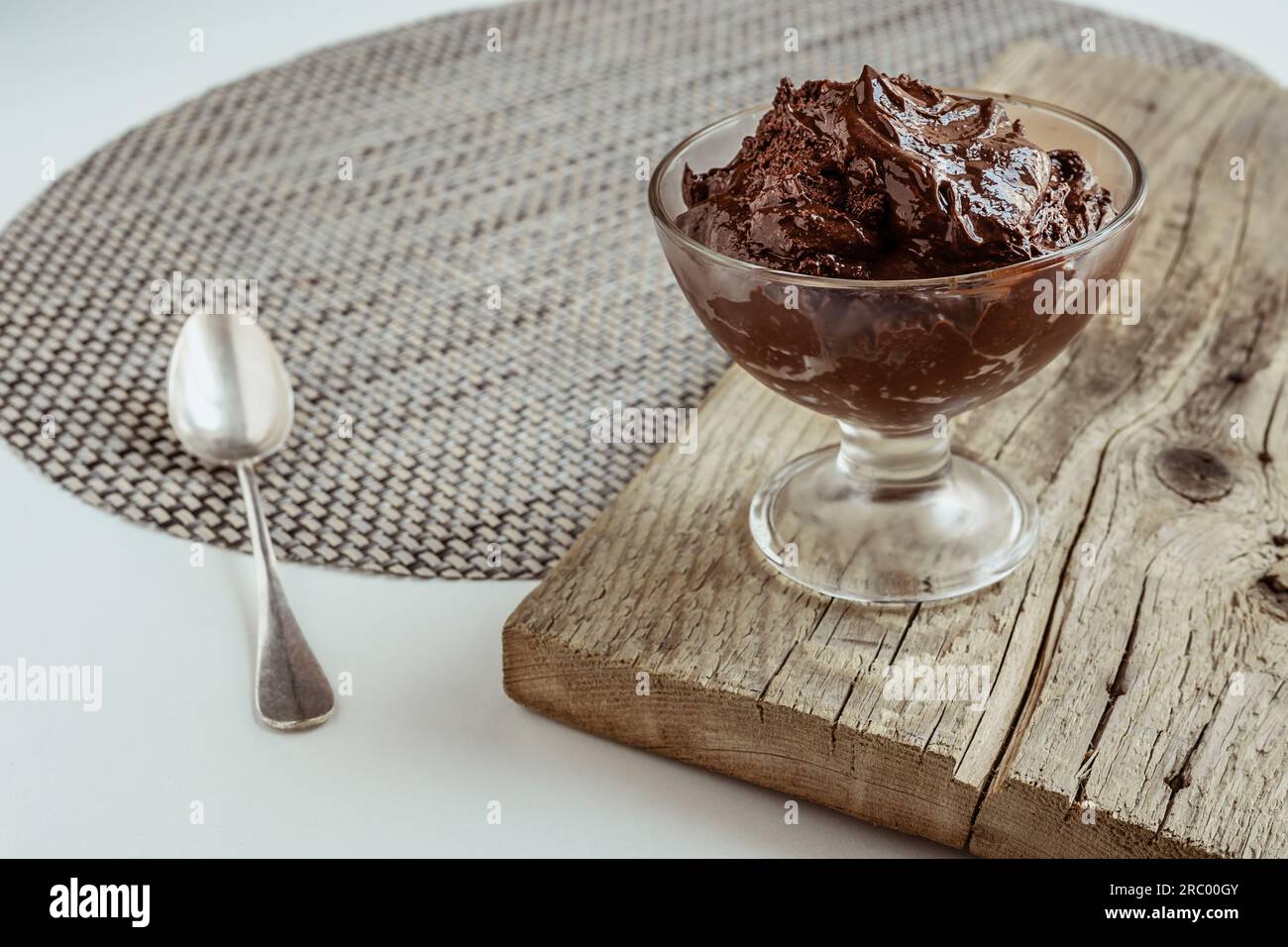 Eine transparente Schüssel mit Schokoladenmousse, traditionelles französisches Dessert auf einem Holzbrett Stockfoto