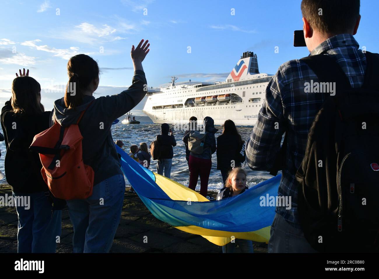 Edinburgh Scotland, Vereinigtes Königreich, 11. Juli 2023. Die Leute winken, während Tug Boote MS Victoria aus den Leith Docks führen. Die Fähre hat ukrainische Flüchtlinge vorübergehend untergebracht. Live-Nachrichten von sst/alamy Stockfoto