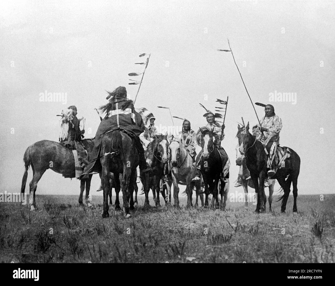 Montana 1908. Eine Edward S. Curtis Fotogravur von Atsina-Kriegern auf dem Pferderücken. Stockfoto