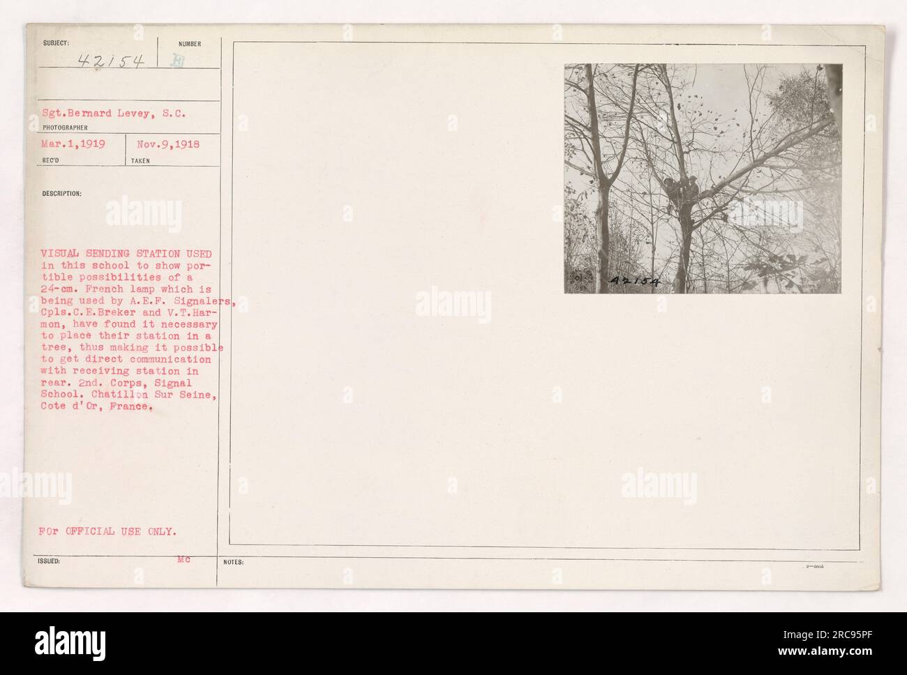 Dieses Bild zeigt eine visuelle Sendestation an der Signalschule des 2. Korps in Chatillon-sur-seine, Frankreich. Die Station wird verwendet, um die Fähigkeiten einer französischen 24-cm-Lampe zu demonstrieren, die von A.E.F-Signalgebern verwendet wird. Corporals C.E. Breker und V.T. Harmon hat die Station in einen Baum gestellt, um eine direkte Verbindung mit der Empfangsstation dahinter herzustellen. Dieses Foto wurde von Sergeant Bernard Levey am 1. März 1919 aufgenommen und am 9. November 1918 erhalten. Es ist nur für den offiziellen Gebrauch bestimmt. Stockfoto
