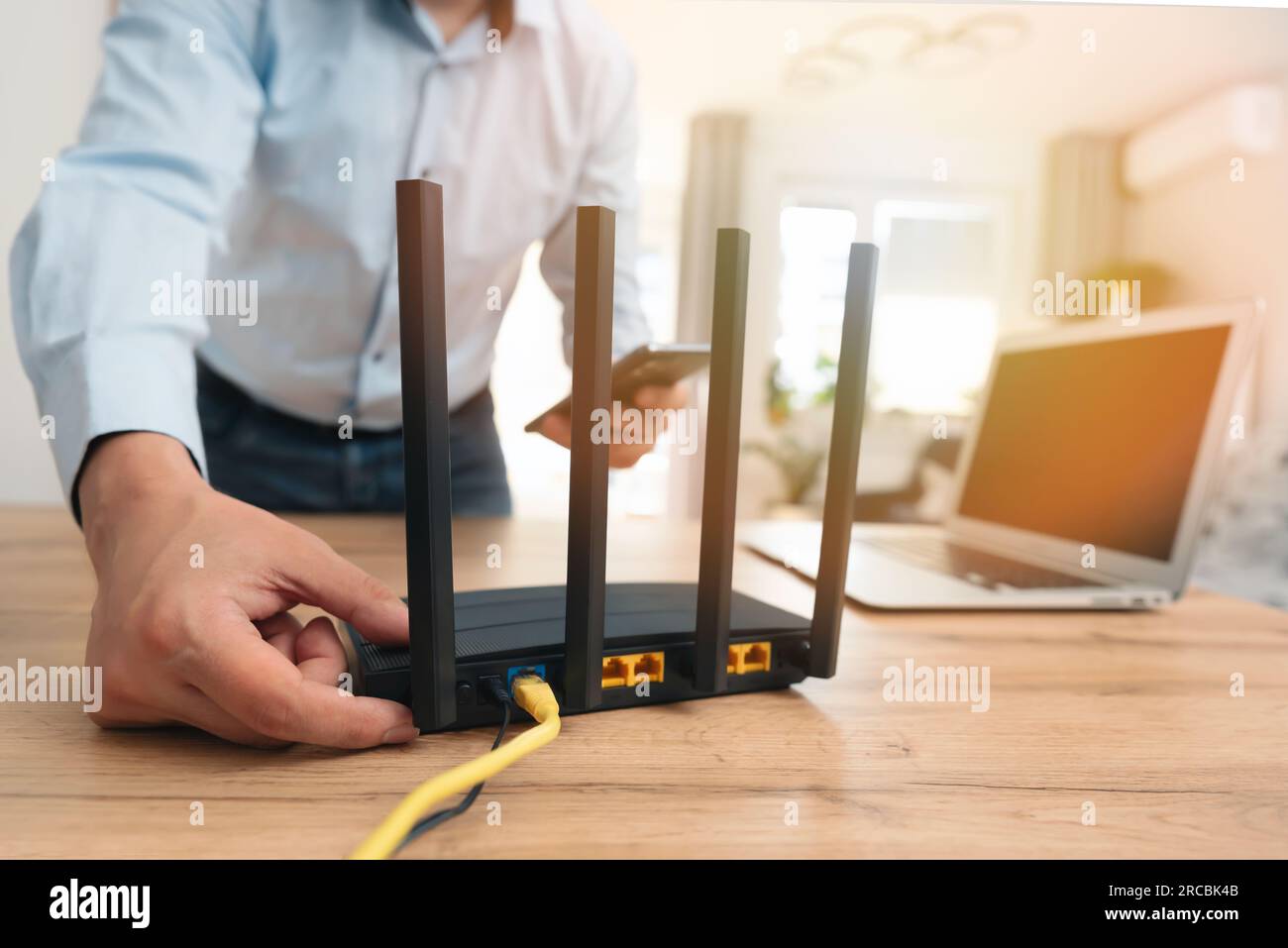Mann, der einen modernen WLAN-Router benutzt, Highspeed-Internet Stockfoto