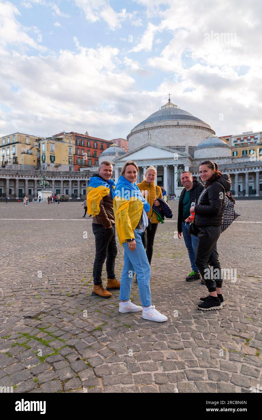 Neapel, Italien - 10. April 2022: Zivilisten, die die Ukraine beim Konflikt mit Russland von 2022 unterstützen, die ukrainische Staatsflaggen außerhalb von Neapel anbinden, Stockfoto