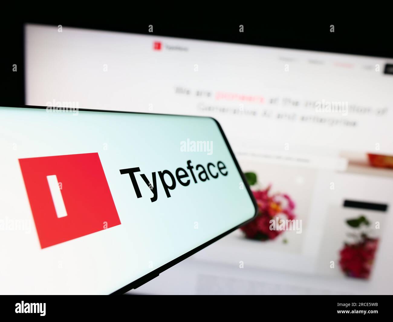 Smartphone mit dem Logo der US-amerikanischen Firma Typeface Inc. Auf dem Bildschirm vor der Website. Fokus auf die Mitte links des Telefondisplays. Stockfoto