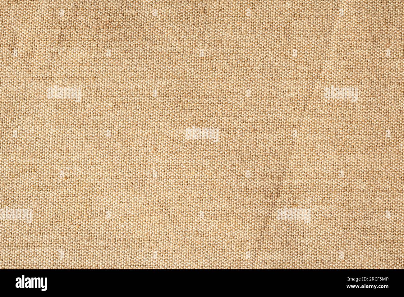 Fein strukturierter Hintergrund aus beigefarbenem Leinengewebe. Stockfoto