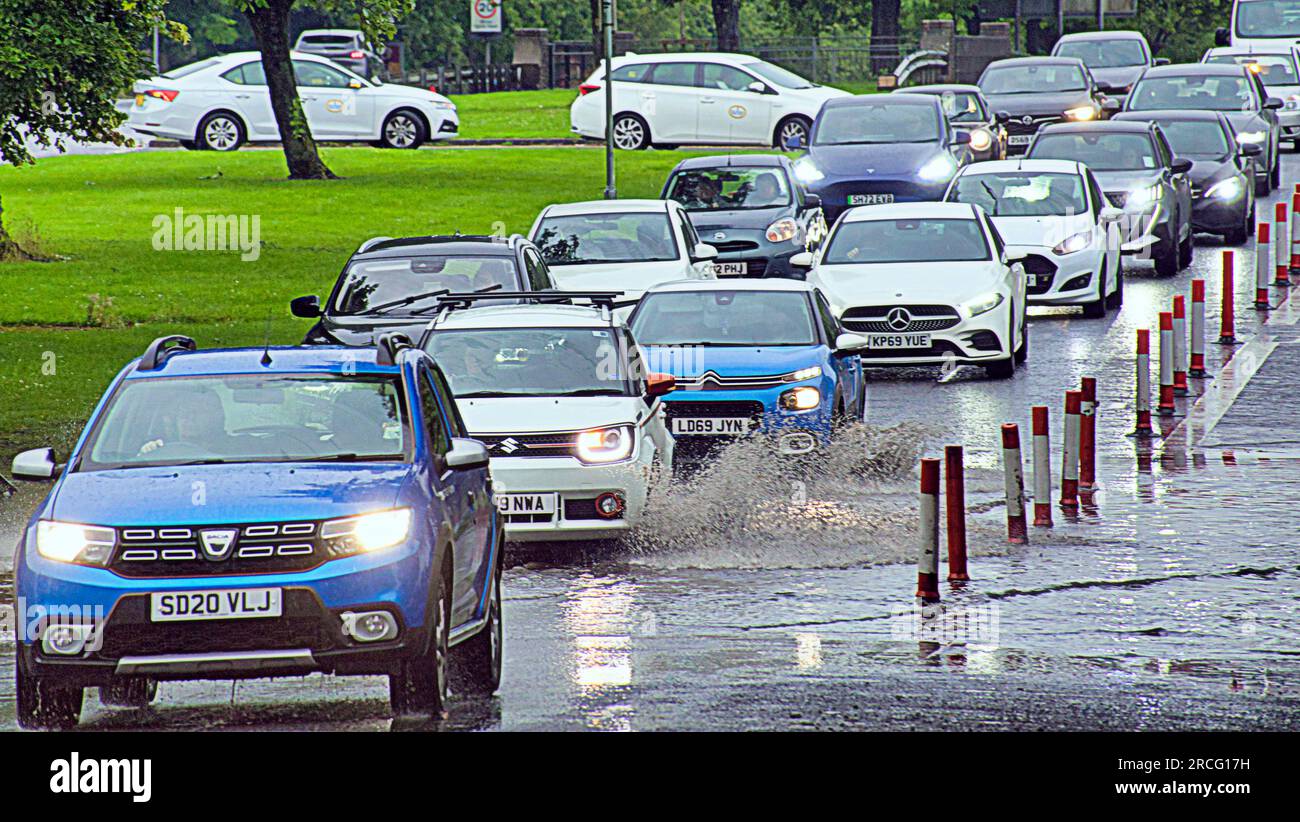 Glasgow, Schottland, Vereinigtes Königreich 14. Juli 2023. UK Weather: Bei starkem Regen kämpfte der Verkehr auf der Great Western Road auf der A82 durch Überschwemmungen, während die Stadt von Regen durchflutet wurde. Credit Gerard Ferry/Alamy Live News Stockfoto