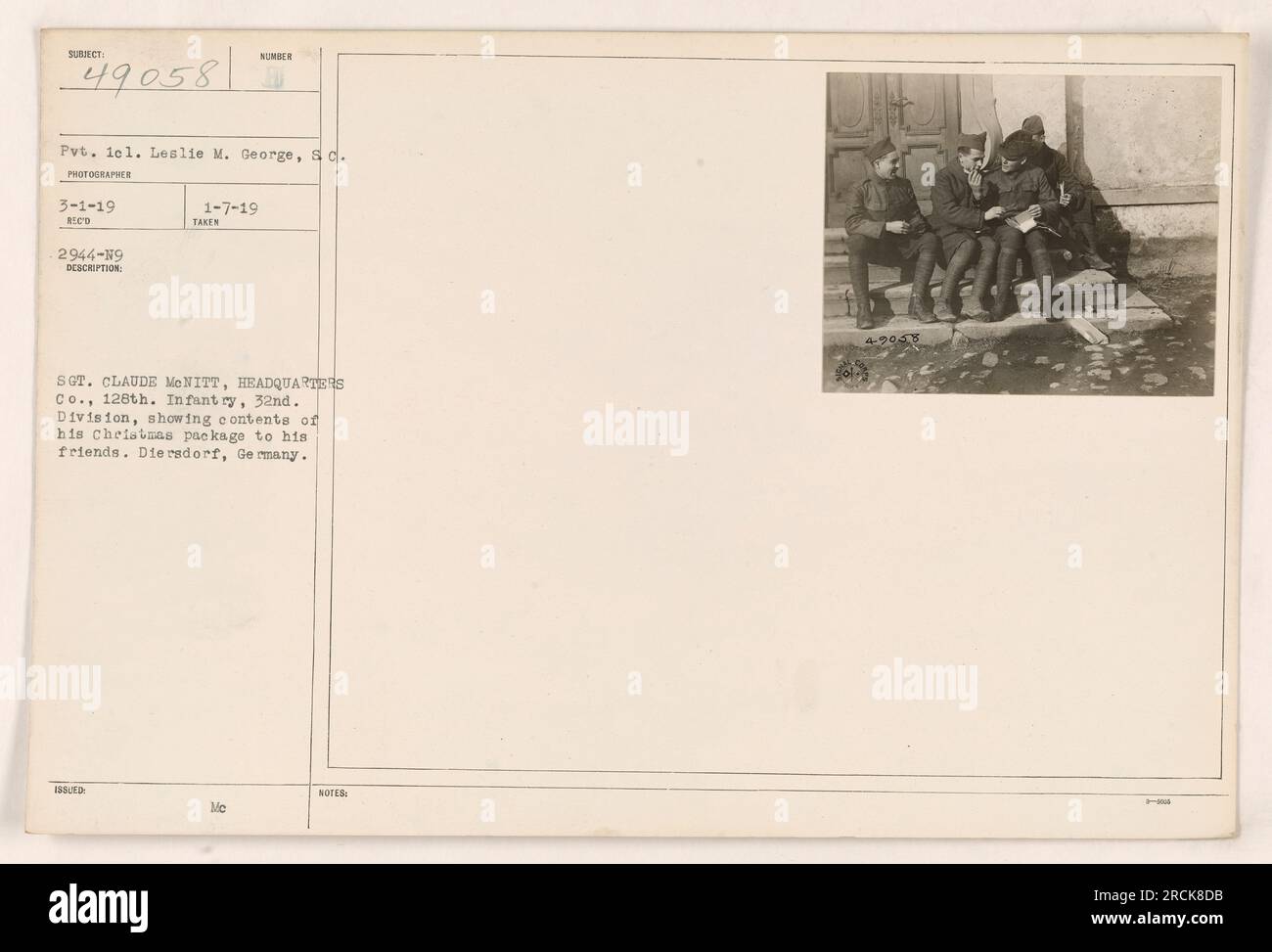 "Sergeant Claude McNitt von Headquarters Co., 128. Infanterie, 32. Division entfaltet den Inhalt seines Weihnachtspakets und zeigt ihn seinen Freunden in Diersdorf, Deutschland. Foto von Pvt. Lel. Leslie M. George am 1. März 1919. Offiziell dokumentiert als Reco 2944-19 und am 7. Januar 1919 mit den Mc-ANMERKUNGEN 4-9058.“ Stockfoto