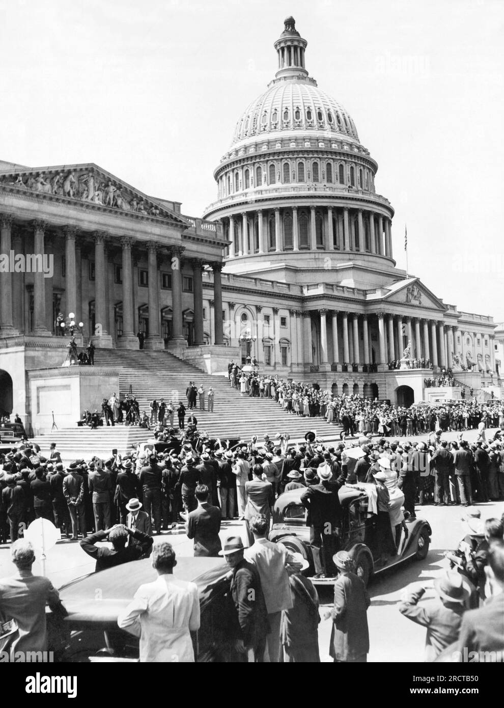 Washington, D.C. Am 22. Mai 1935 versammeln sich vor dem Kapitol Menschenmassen, während sie Präsident Roosevelt anfeuern, als er in seinem Auto wegfuhr, nachdem er persönlich vor einer gemeinsamen Kongresssitzung gegen das Soldiers Bonus Bill protestiert hatte. Stockfoto