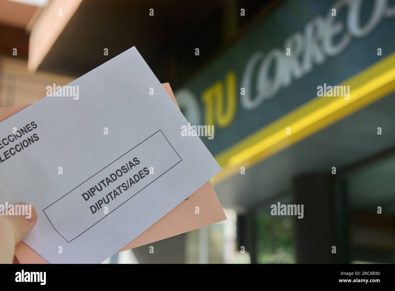 Zwei Stimmzettel für die Parlamentswahlen in Spanien mit dem Correos-Logo im Hintergrund Stockfoto