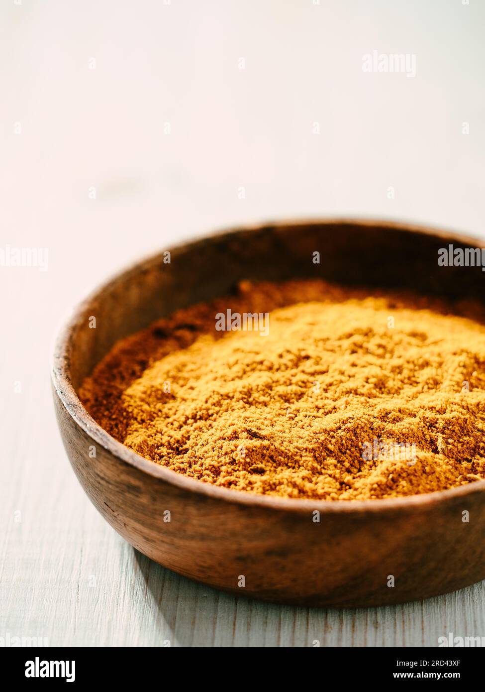Indisches oder pakistanisches Masala Pulver in kleiner Holzschale. Hausgemachte trockene Curry Garam Masala Mischung Gewürze Mischung auf weißem Holzhintergrund mit Kopie Raum. V Stockfoto