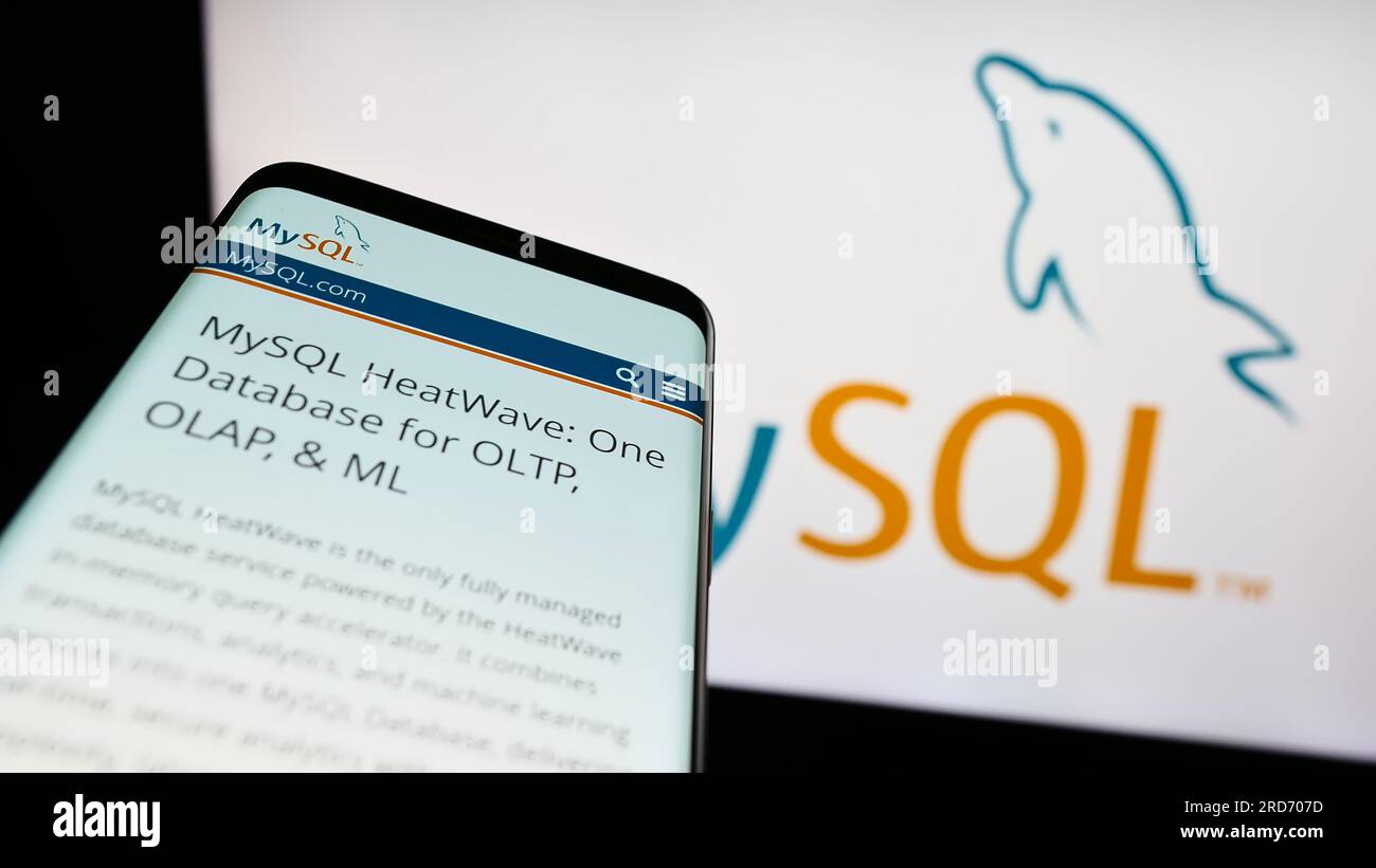 Mobiltelefon mit Webseite des relationalen Datenbankmanagementsystems MySQL auf dem Bildschirm vor dem Logo. Fokus auf oberer linker Seite des Telefondisplays. Stockfoto