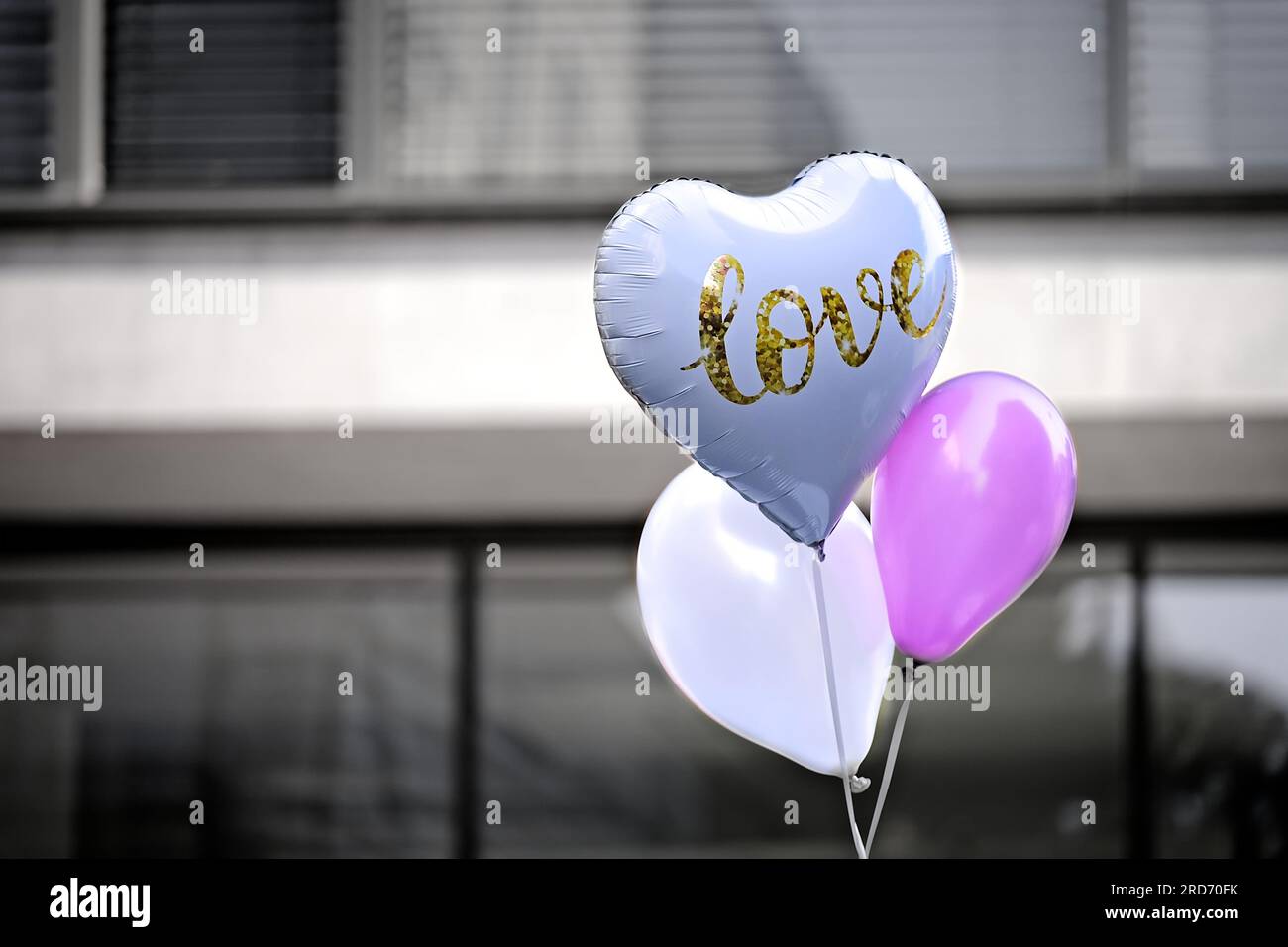 Herzförmiger Ballon mit Love-Inschrift. Horizontales Bild mit selektivem Fokus. Stockfoto