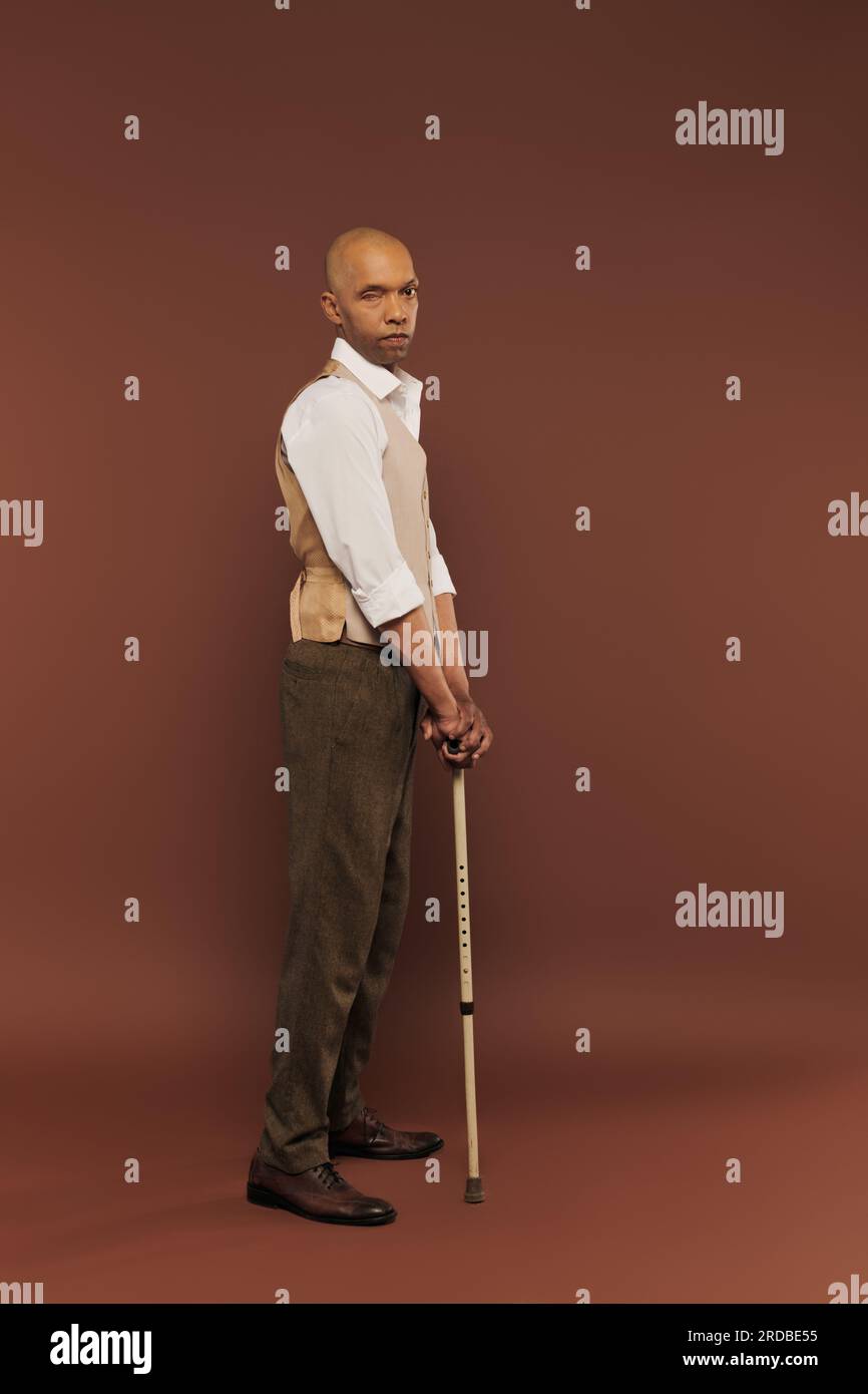 Inklusion, Myasthenia-gravis-Syndrom, mutiger afroamerikanischer Mann, der mit einem Stock steht, in die Kamera schaut, dunkelhäutig, echte Menschen, neurologisch Stockfoto