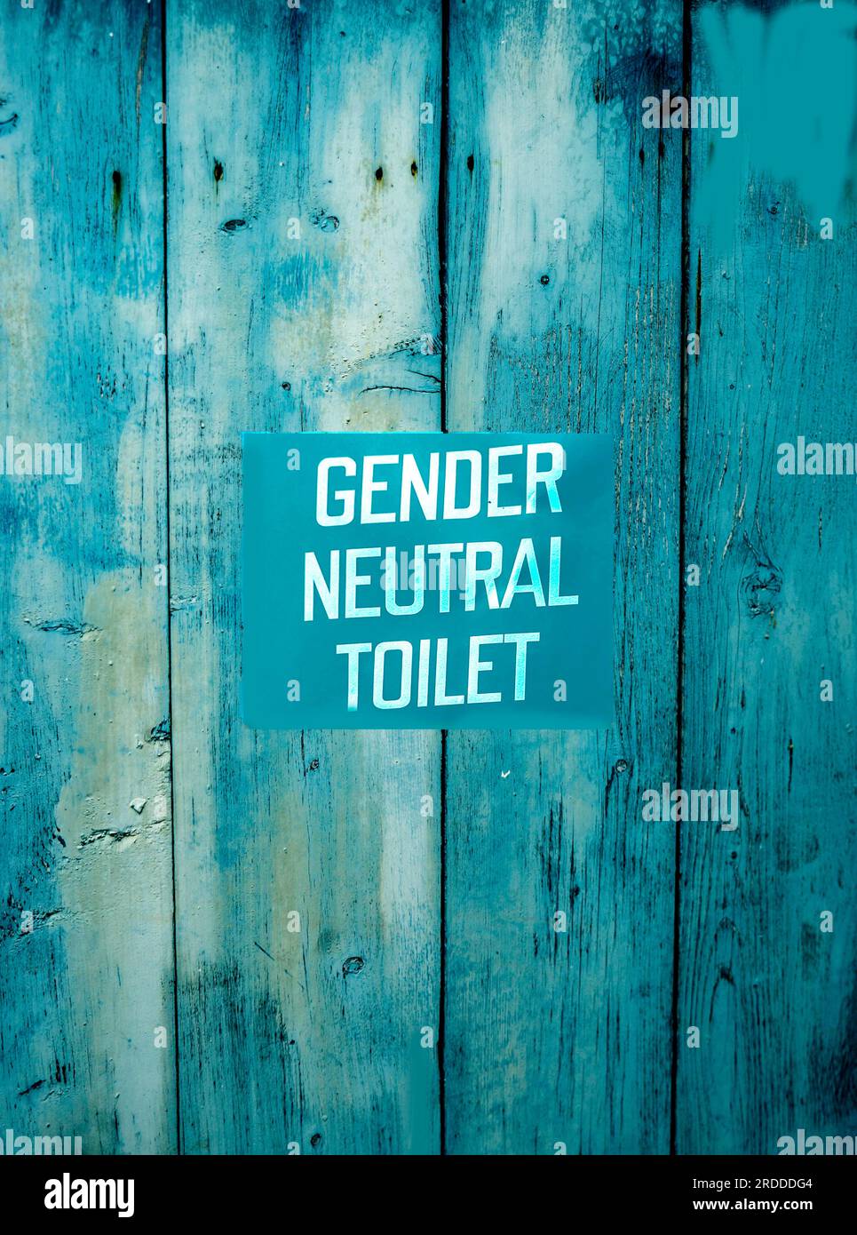 Eine Toilettentür mit einem geschlechtsneutralen Schild. Stockfoto