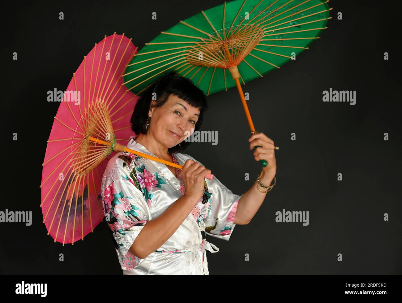 Asiatischer Tanz mit Regenschirmen Stockfoto