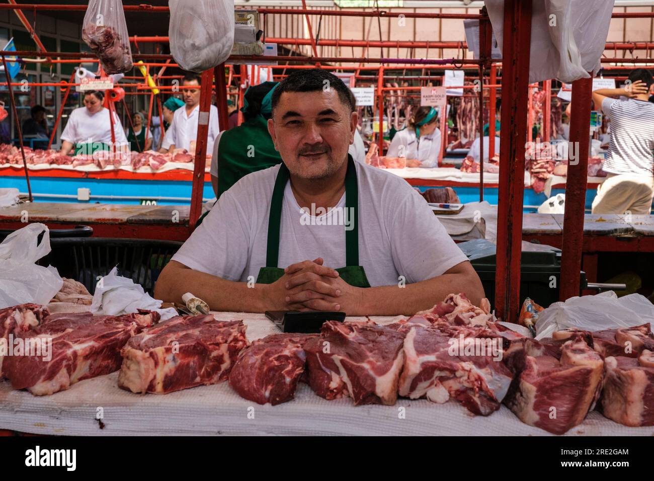 Kasachstan, Almaty. Green Bazaar Lieferant von Fleischstücken. Stockfoto