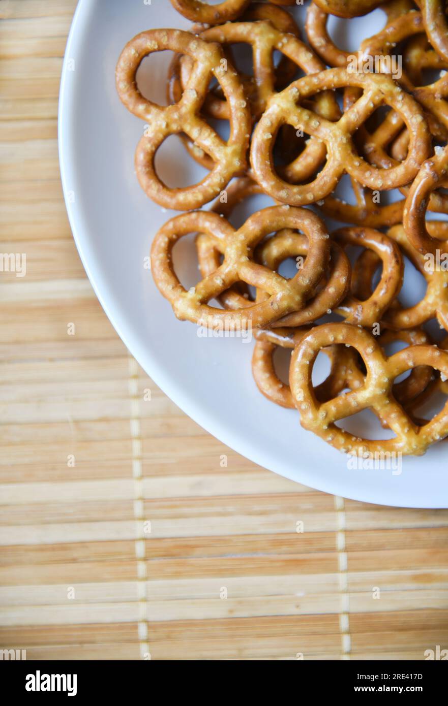 Salzige, köstliche Brezel auf einem weißen Teeteller. Gesundes Essen. Stockfoto