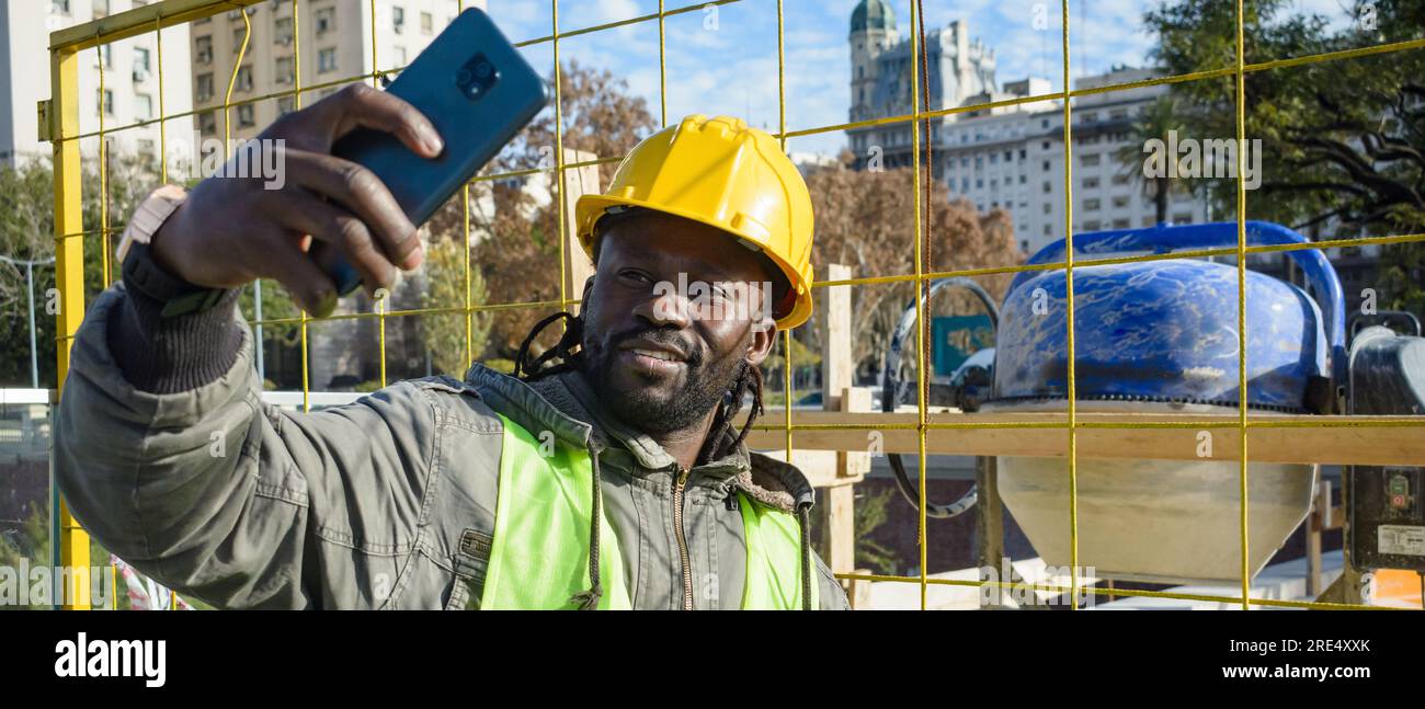 Bauarbeiter mit helm und weste macht ein selfie auf der baustelle