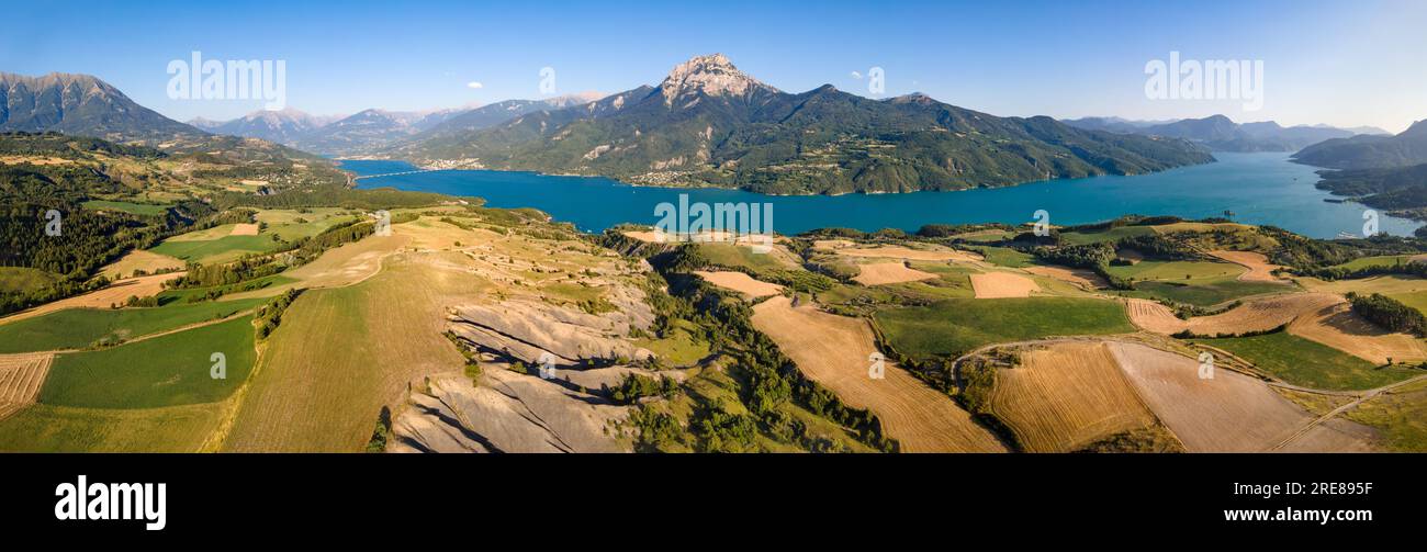 Panoramablick aus der Vogelperspektive auf den Serre-Poncon-See und den Grand Morgon-Gipfel mit dem Dorf Savines-le-Lac und der Bucht von Saint-Michel. Hautes-Alpes, Alpen, Frankreich Stockfoto