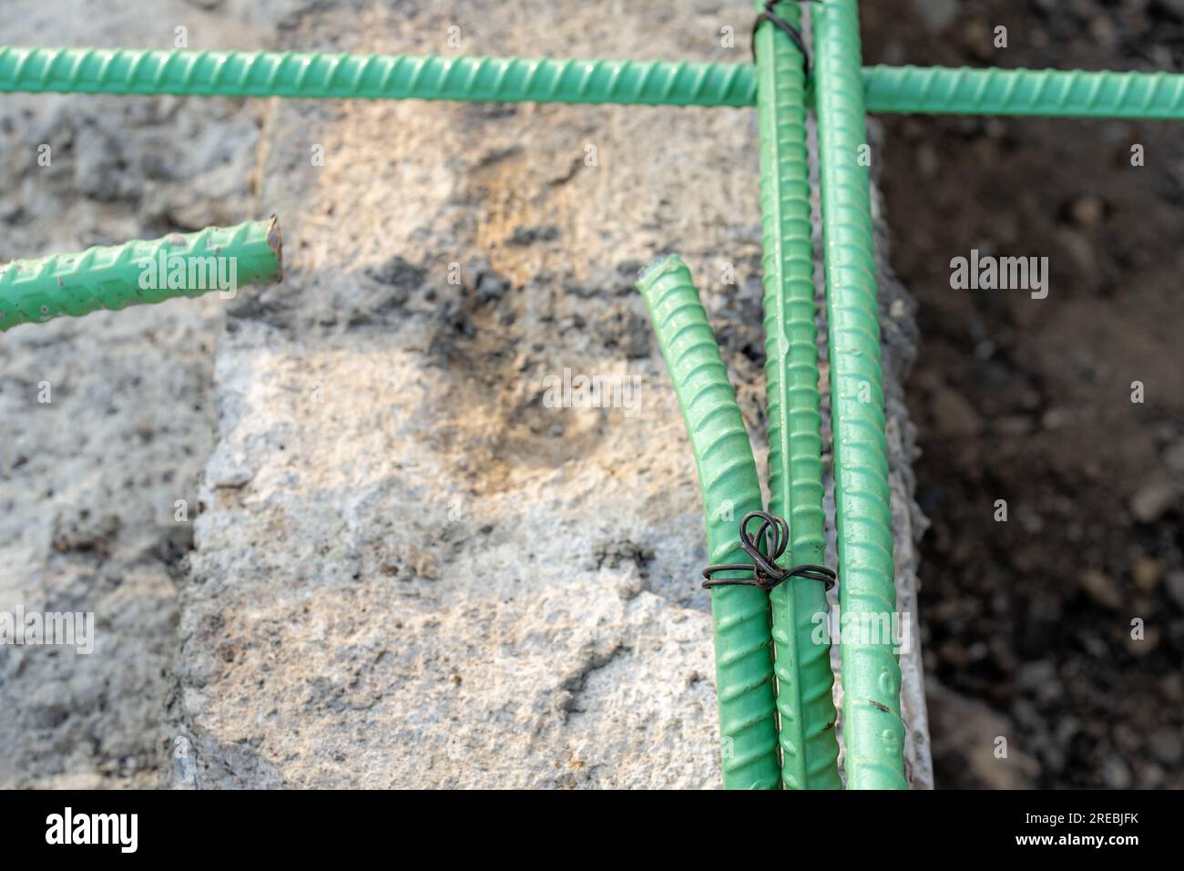 Epoxidbeschichteter Bewehrungsstahl wird in Beton verwendet, der korrosiven Bedingungen ausgesetzt ist. Dazu kann die Exposition gegenüber Enteisungssalzen oder Meeresumgebungen gehören. Stockfoto