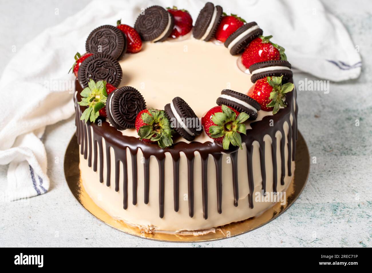 Schokoladenkuchen. Flüssige Schokolade und Erdbeeren-Geburtstagskuchen auf grauem Hintergrund Stockfoto