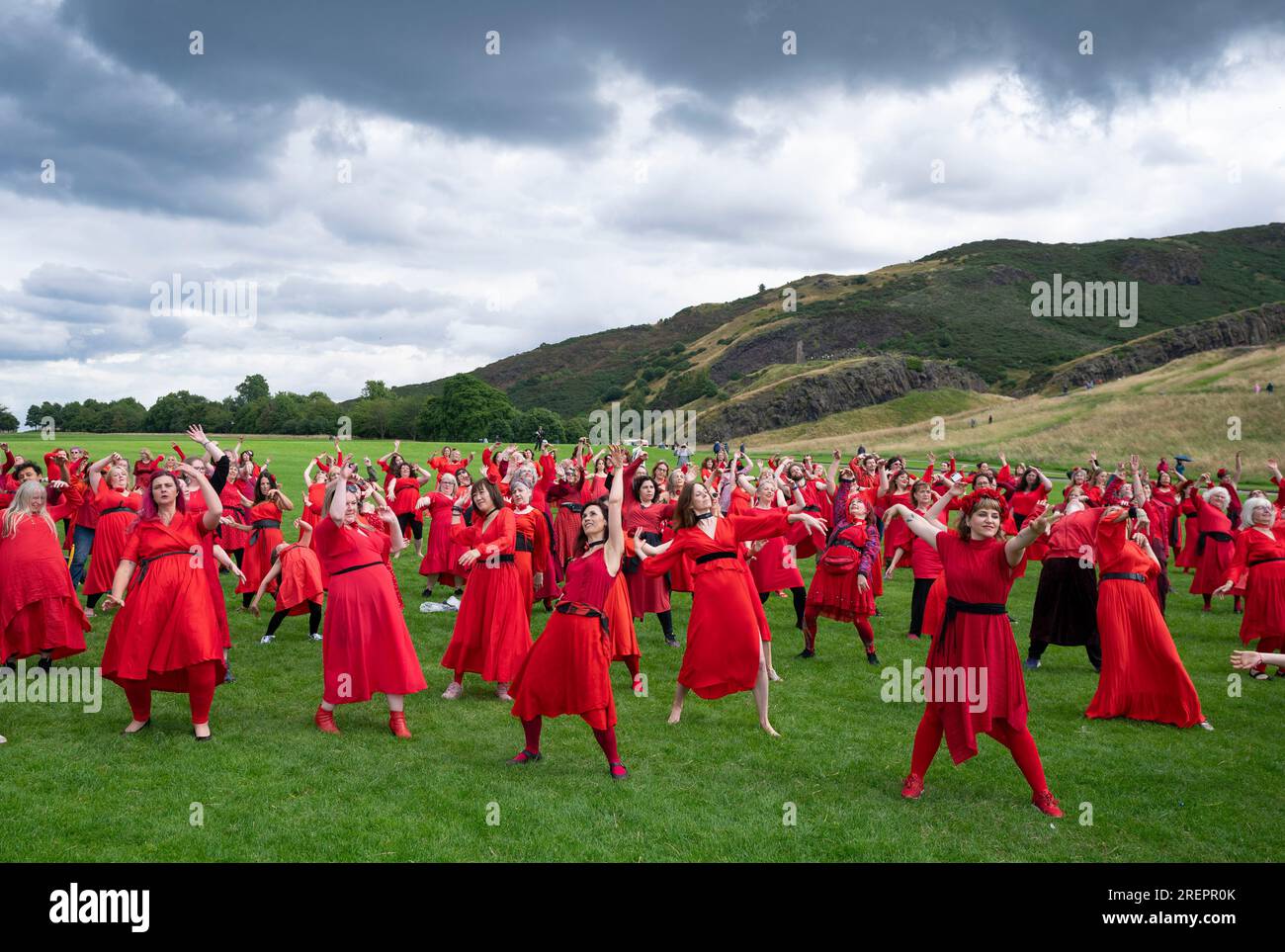 Edinburgh, Schottland, Großbritannien. 29. Juli 2023 Dutzende Frauen in roten Kleidern treffen sich im Holyrood Park, um zu tanzen und den alljährlichen „Most Wuthering Heights Day“ zu feiern – eine Hommage an die Musik von Kate Bush. Iain Masterton/Alamy Live News Stockfoto