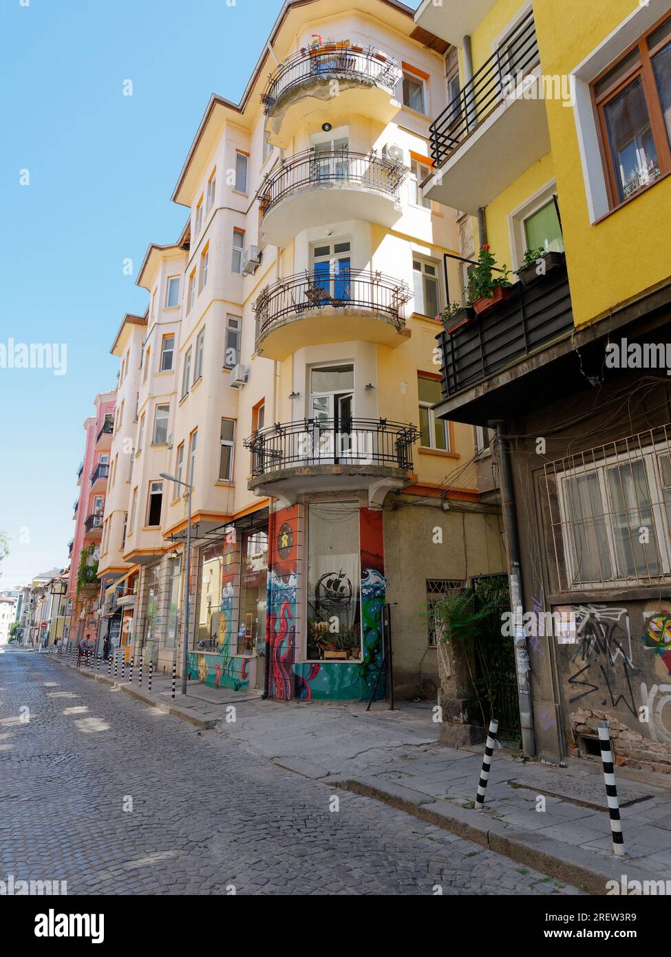 Tellow und weißer Apartmentblock mit Graffiti und Street Art darunter. Sofia, Bulgarien. Juli 2023 Stockfoto
