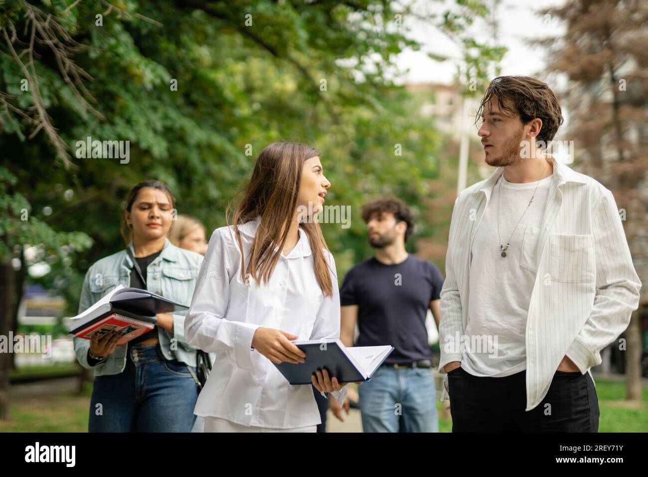 Teenager-Gruppe von High-School-Schülern, die auf ihre Schule zugehen, miteinander reden, Universität, Dozenten-Schüler Stockfoto