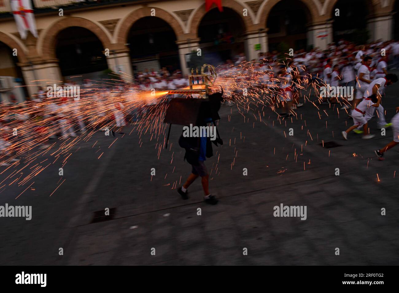 Revelers run along the bull fire in the small village of Tudela, northern Spain, Sunday, July 30, 2023, during the regional fiestas in honor of the patron Saint Ana. (AP Photo/Alvaro Barrientos) Stockfoto