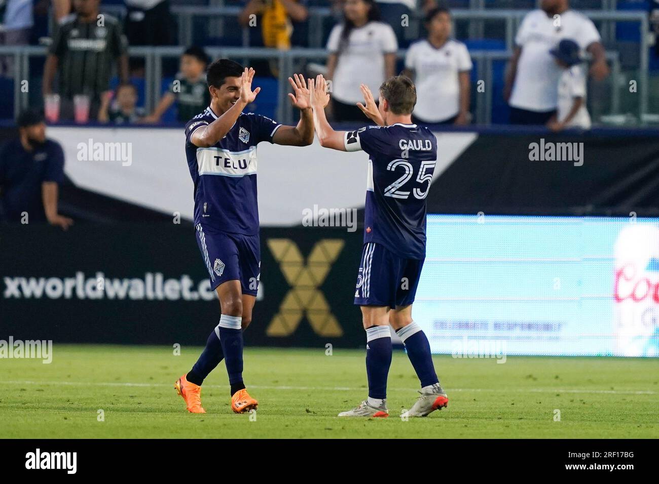 Vancouver Whitecaps midfielder Ryan Gauld (25) high-fives teammate Mathías Laborda after an own goal by Los Angeles Galaxy defender Lucas Calegari (2) during the second half of a Leagues Cup soccer match, Sunday, July 30, 2023, in Carson, Calif. (AP Photo/Ryan Sun) Stockfoto