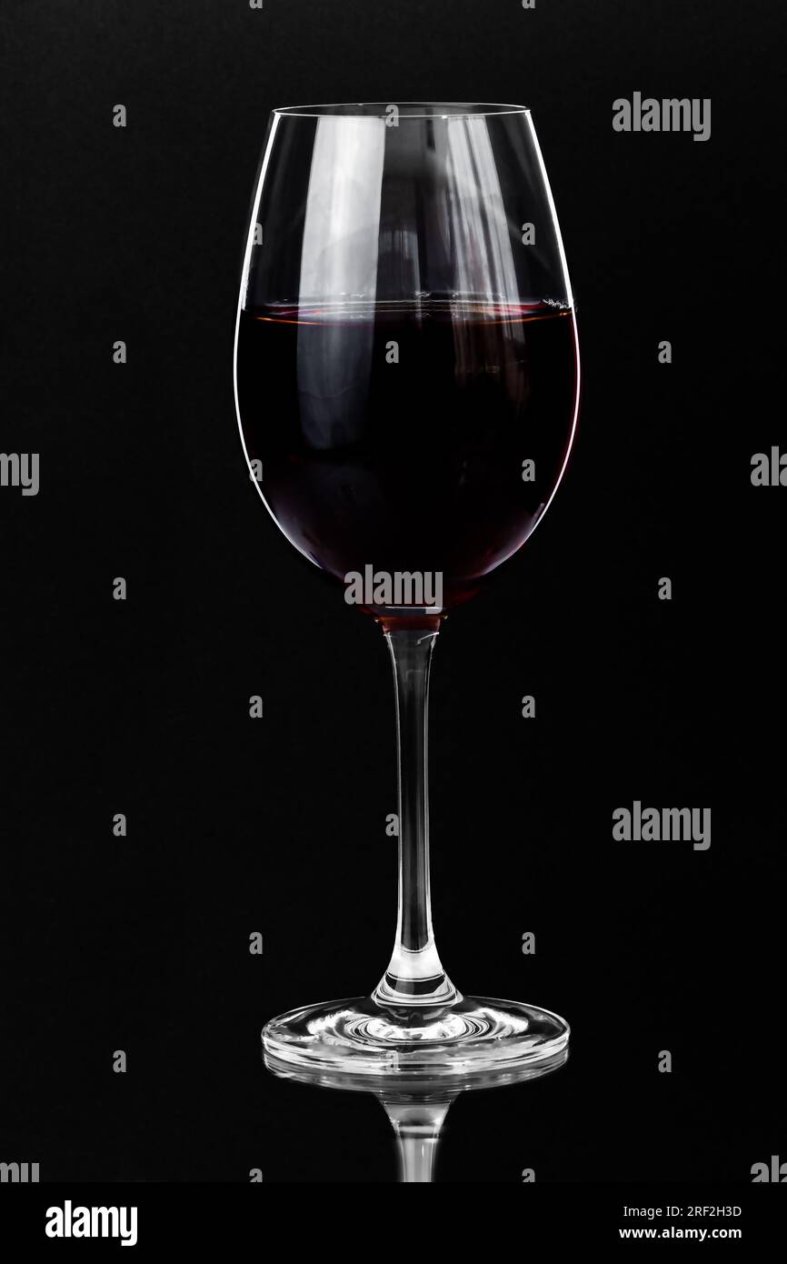 Rotwein in einem Glas auf dunklem Hintergrund mit Kopierbereich Stockfoto