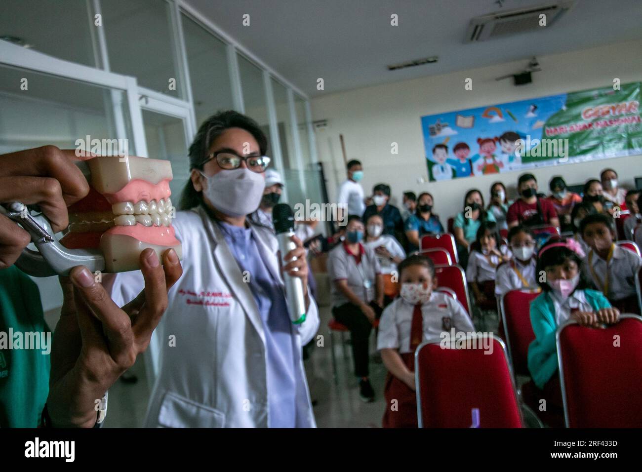 Zahnärzte informieren Grundschüler, die das Vania Bogor Hospital in Indonesien besuchen, über die Aufrechterhaltung der Zahnhygiene und -Gesundheit Stockfoto