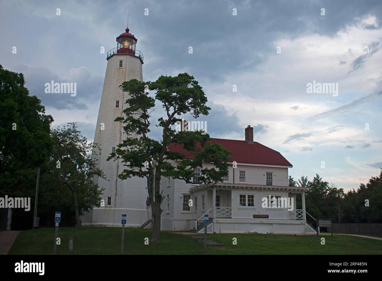 Der Sandy Hook Lighthouse in Fort Hancock in Sandy Hook, New Jersey -87, ist von Regenfällen und stürmischen Wolken bedroht Stockfoto