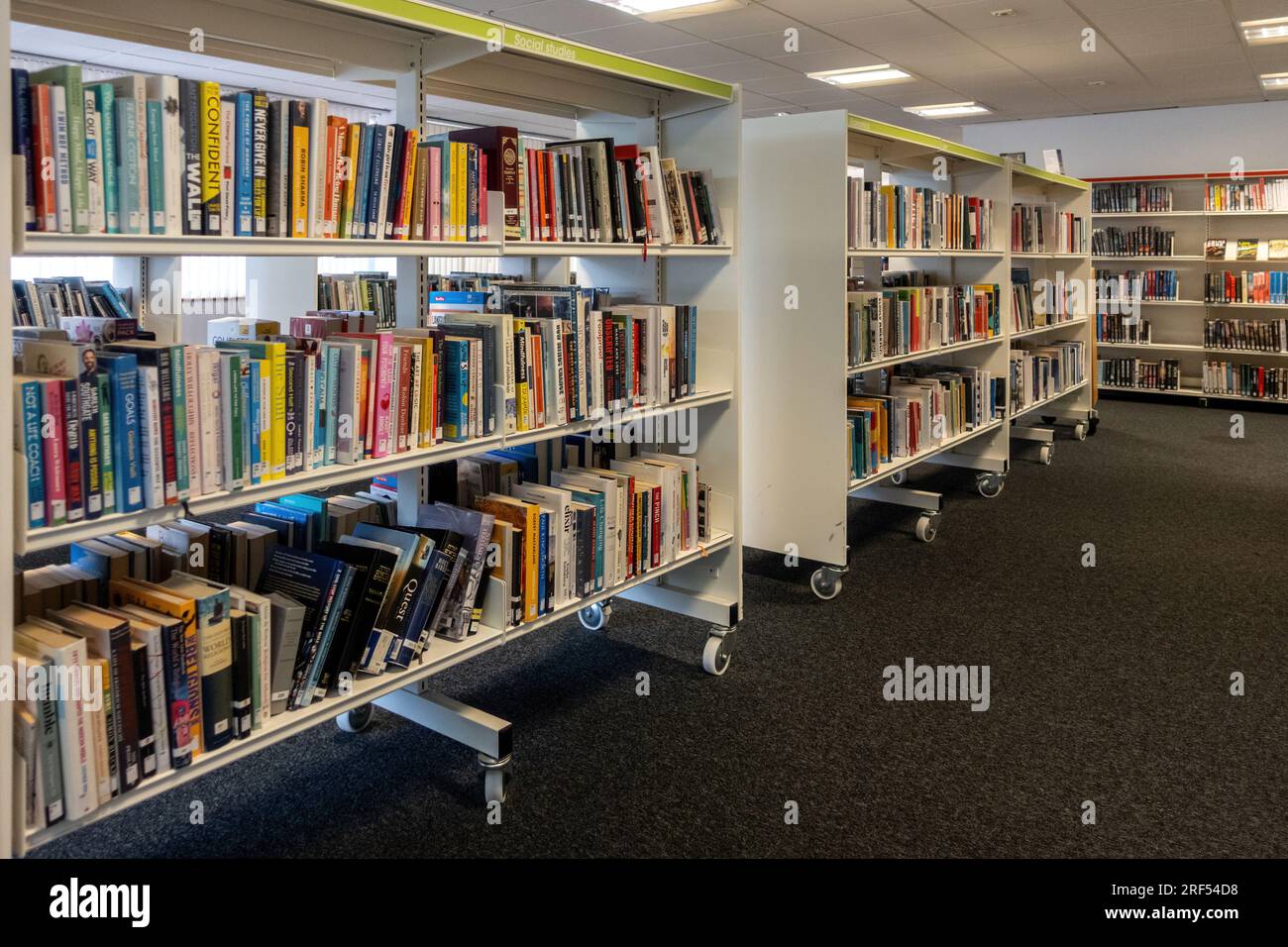 Inneneinrichtung der lokalen Bibliothek der Stadt Farnborough mit Büchern, die in Regalen ausgeliehen werden können, Hampshire, England, Großbritannien Stockfoto