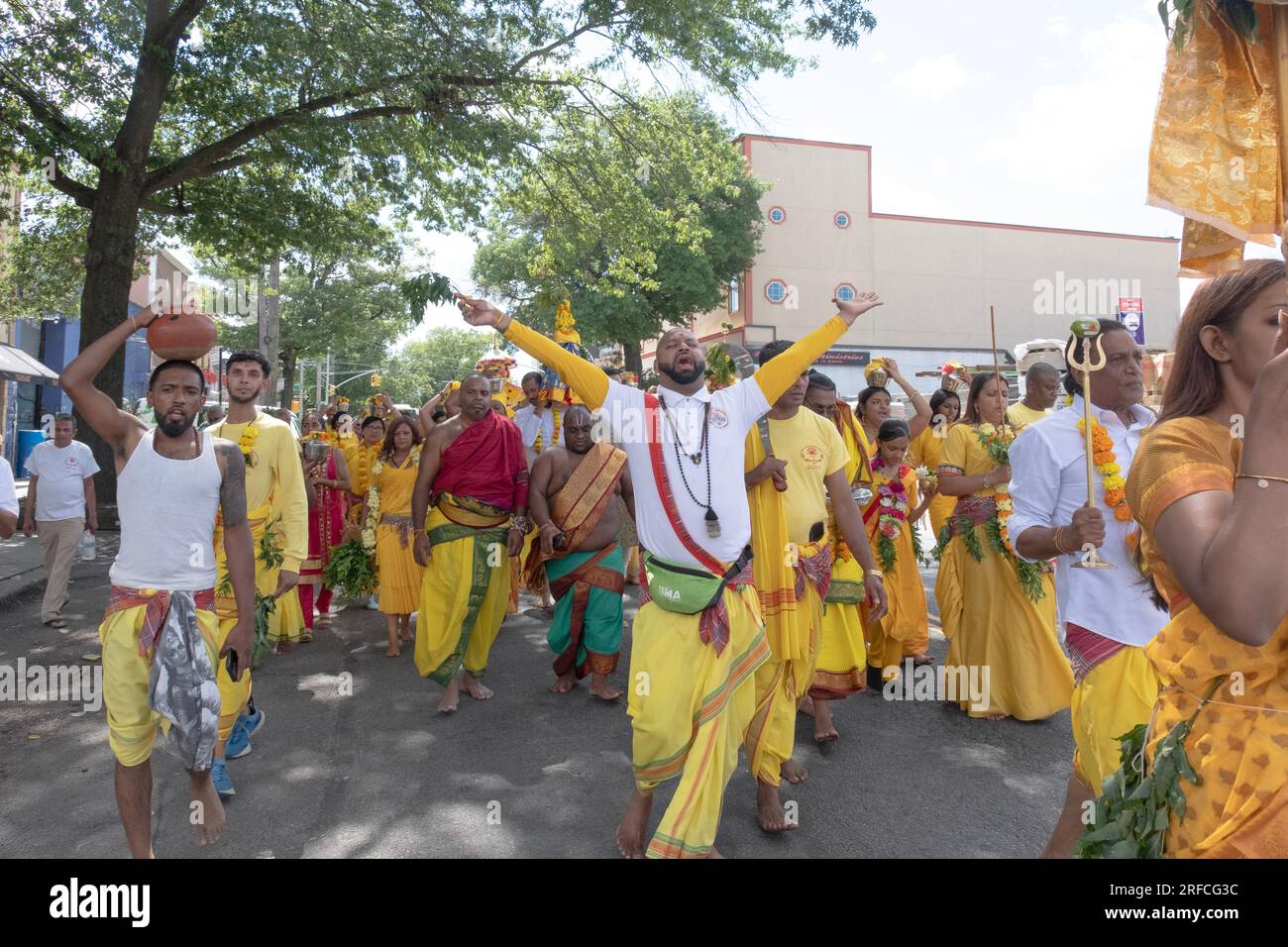 Eine Gruppe frommer Hindus in ethnischer Kleidung marschiert von ihrem Tempel im Ozone Park zum spirituellen Arya-Gelände für einen Feuerspaziergang. Stockfoto