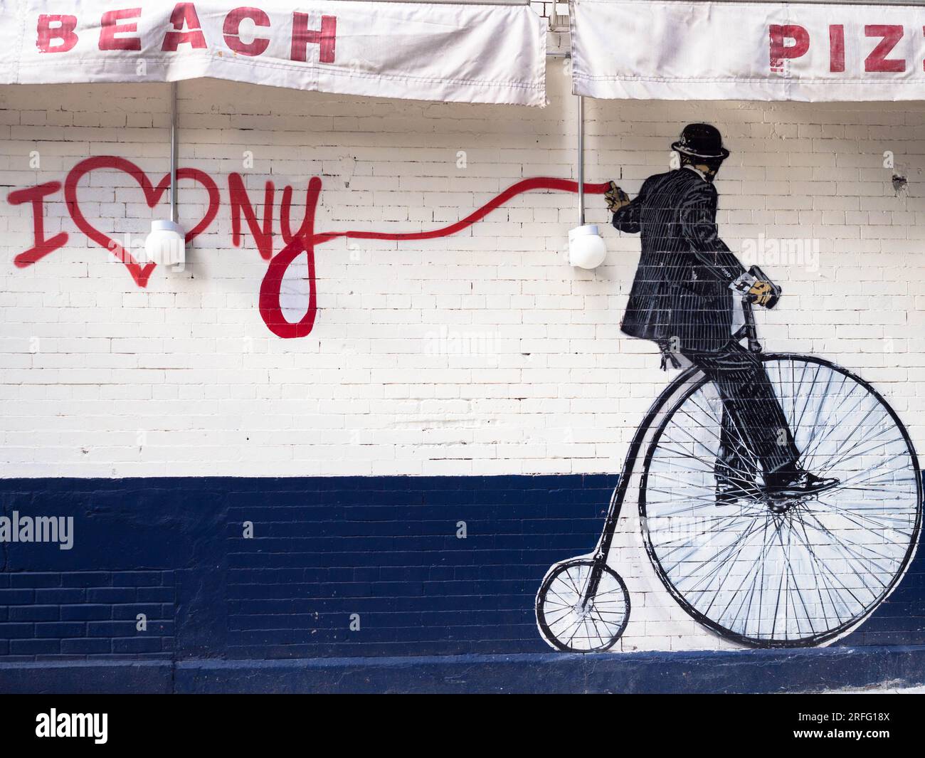 Wandgemälde im Banksy-Stil eines Mannes auf einem Penny-Farthing, der Graffiti neben einer Manhattan-Pizzeria spritzt. Stockfoto