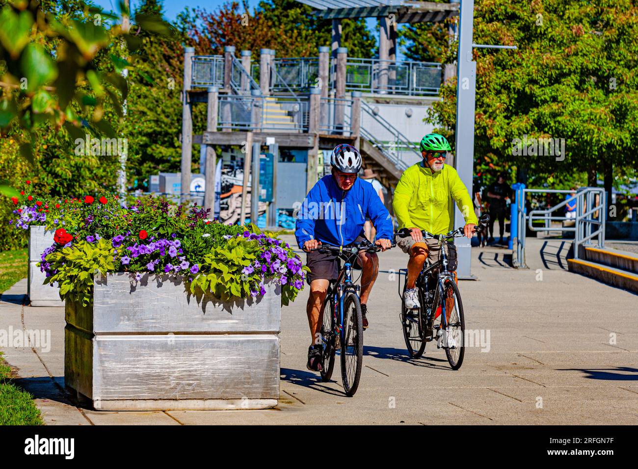 Zwei ältere Herren, die mit dem Fahrrad entlang der Steveston Waterfront in British Columbia, Kanada, gefahren sind Stockfoto