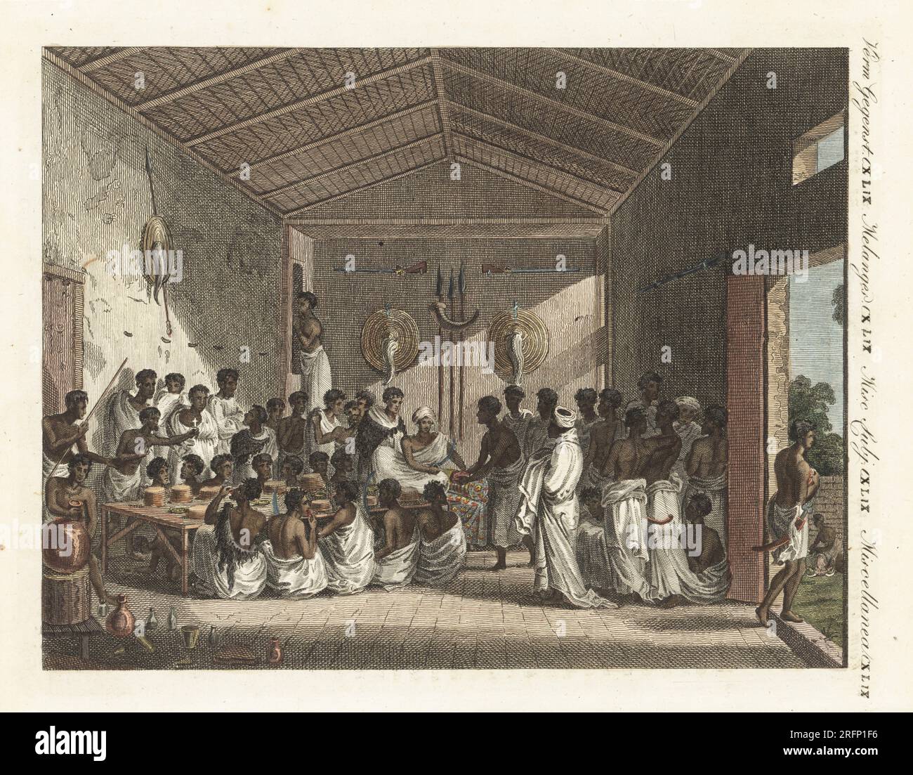 Brinde-Fest am 25. September 1805, vom Gouverneur von Tigray, Abessinien (Äthiopien), auf einem Diwan. Der Zeremonienmeister hat einen langen Stab, ein Fastenmann hält ein Kreuz und ein Junge plündert unter dem Tisch. Weibliche Sklaven bringen Teff-Brot in Hühnchen und Hammelcurry zu sitzenden Männern. Grand festin donne par le Ras de Tigre en Abyssinie. Handfarbene Kupferplattengravierung aus Bilderbuch fur Kinder (Bilderbuch für Kinder) von Carl Bertuch, Weimar, 1810. Eine Enzyklopädie mit 12 Bänden für Kinder, illustriert mit fast 1.200 gravierten Platten über Naturgeschichte, Wissenschaft, Kostüm, m Stockfoto