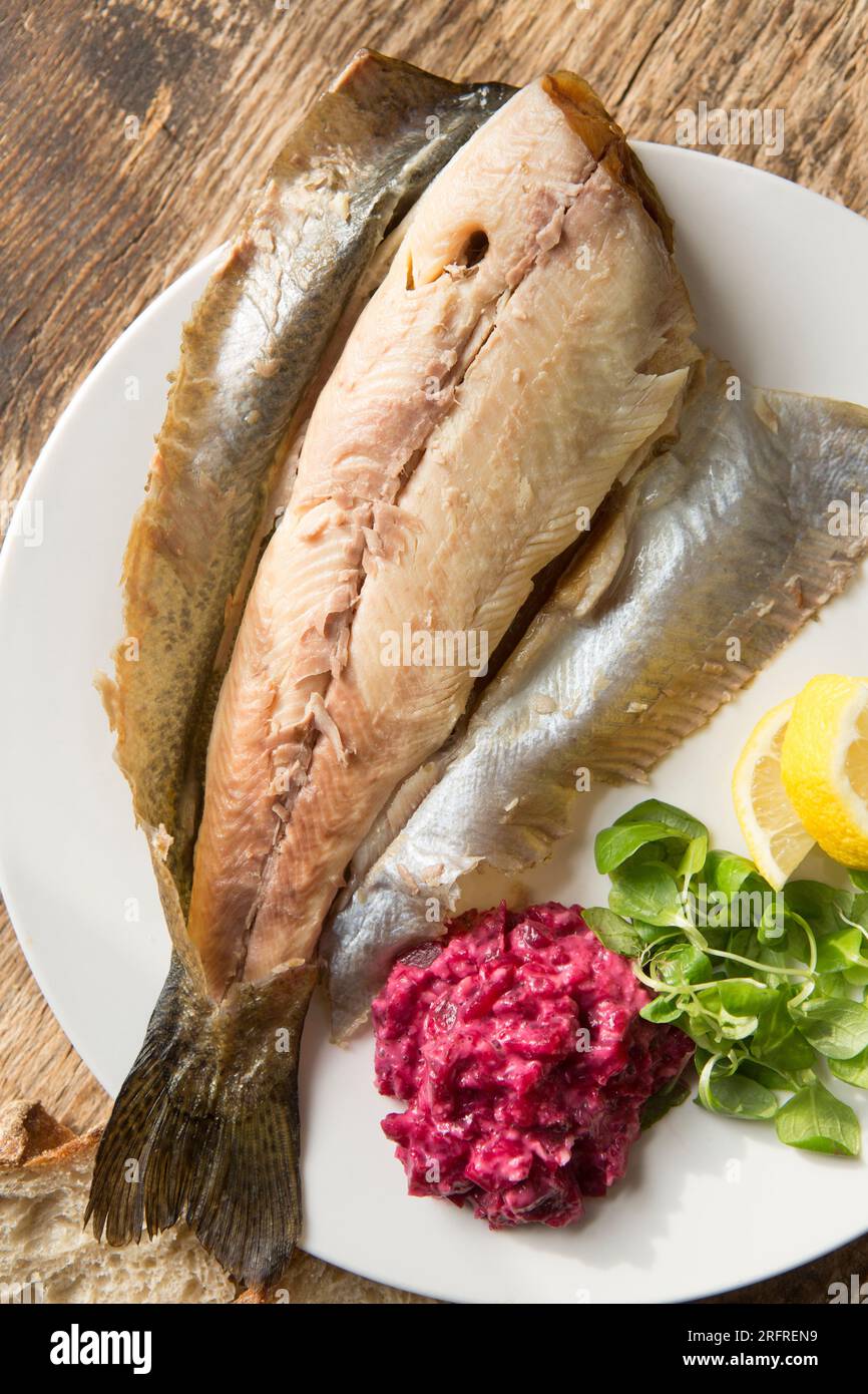 Heiße geräucherte Regenbogenforelle, Oncoryhnchus mykiss, serviert mit Meerrettich- und Rote-Bete-Sauce, Lammsalat und Zitronenscheiben. England GB Stockfoto